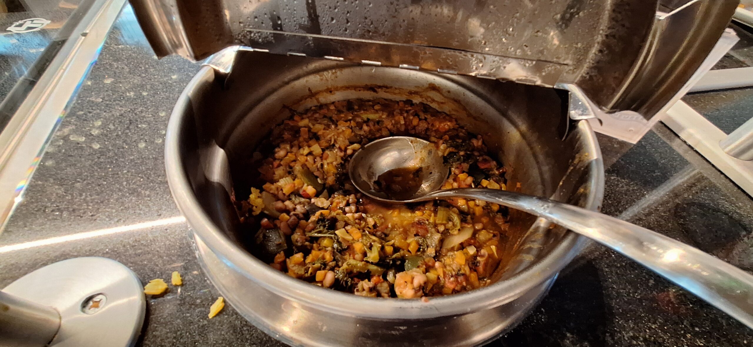 a metal bowl with food in it