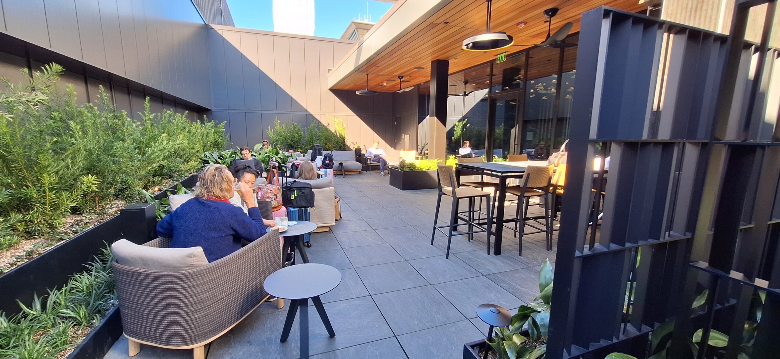 a group of people sitting at tables outside a building