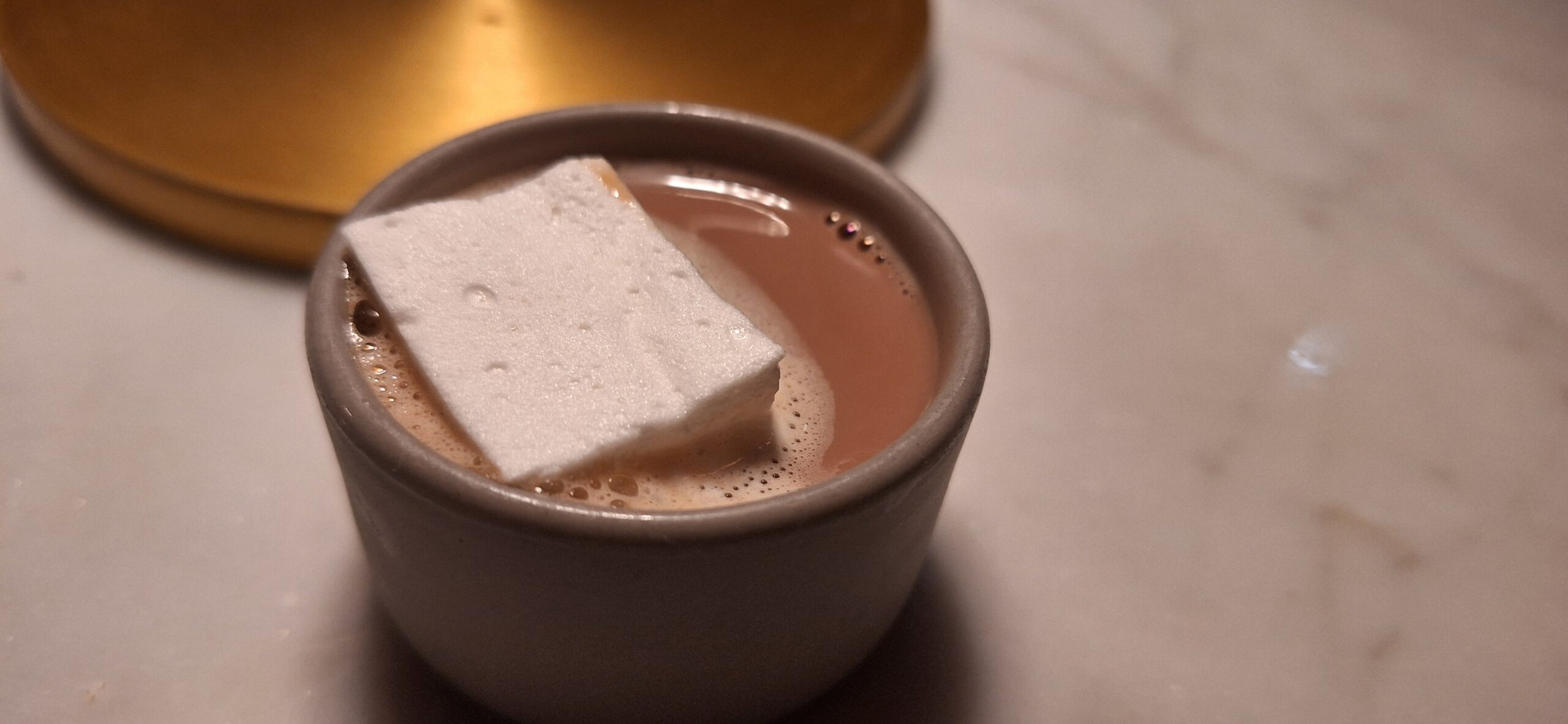 a cup of hot chocolate with a white marshmallow on top