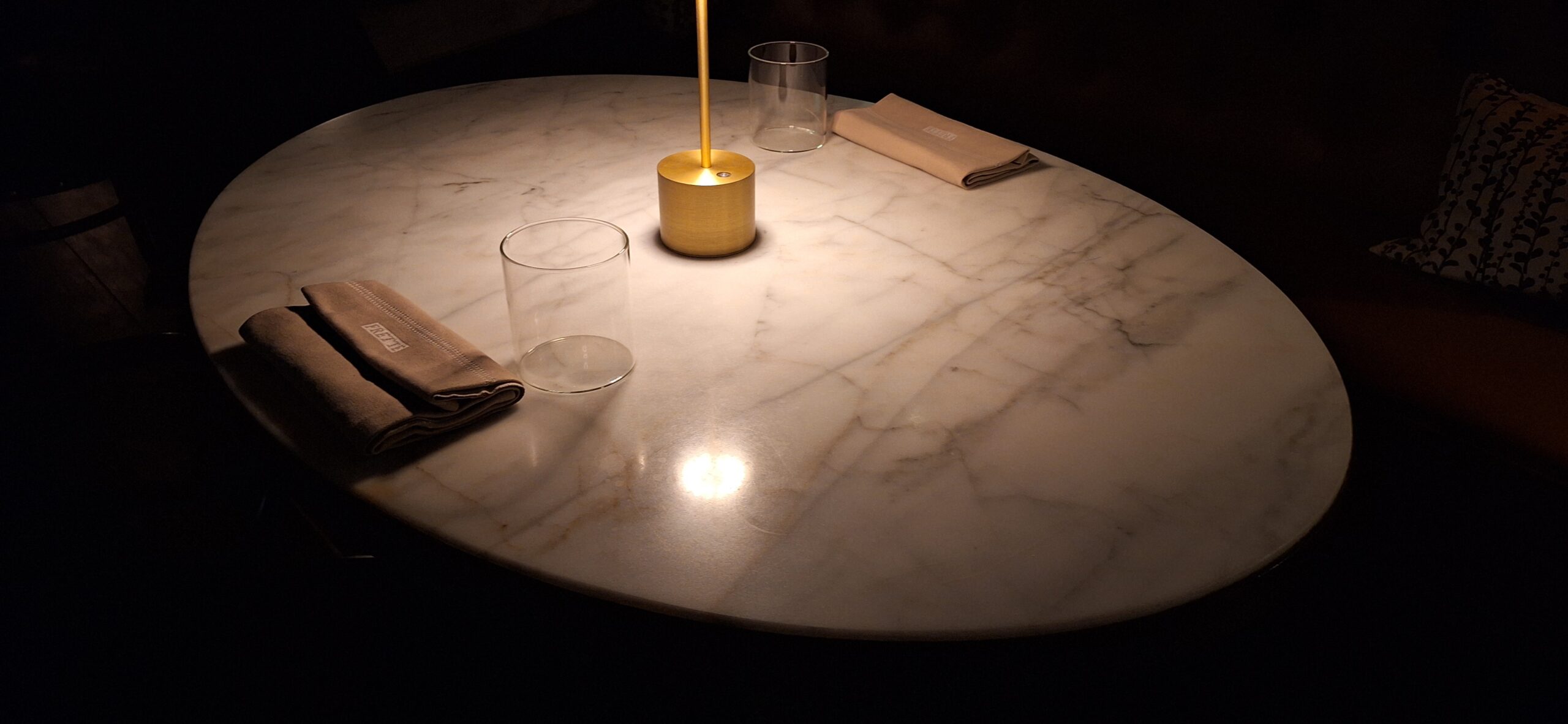 a table with a candle and glasses