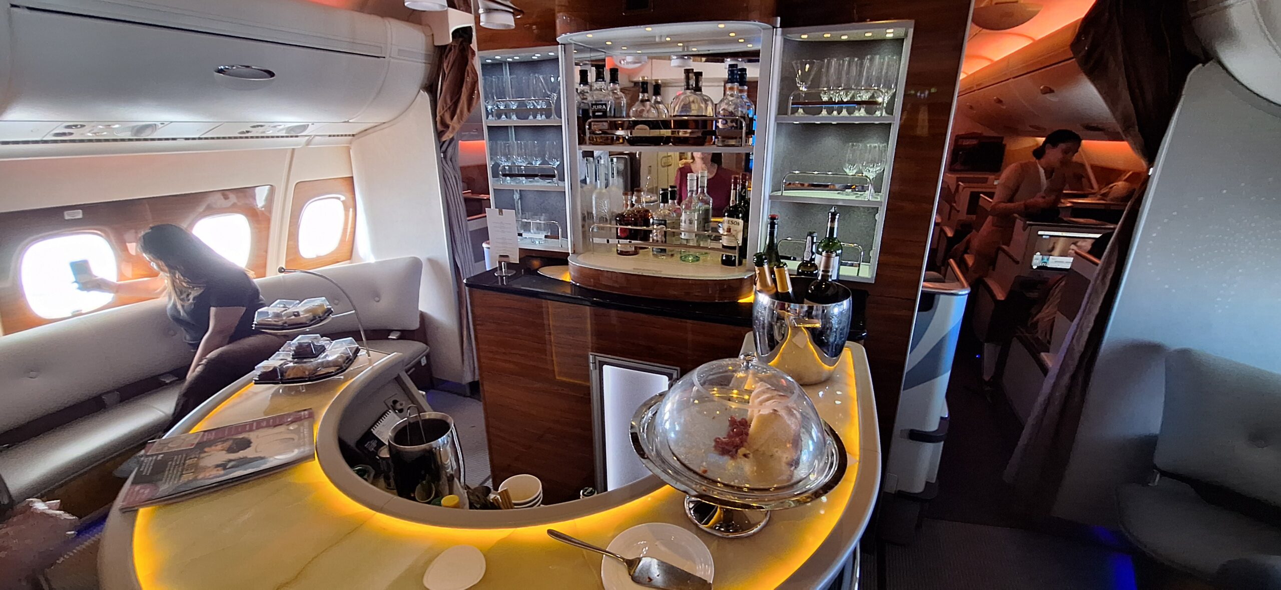 a bar with a glass cover and a tray of wine