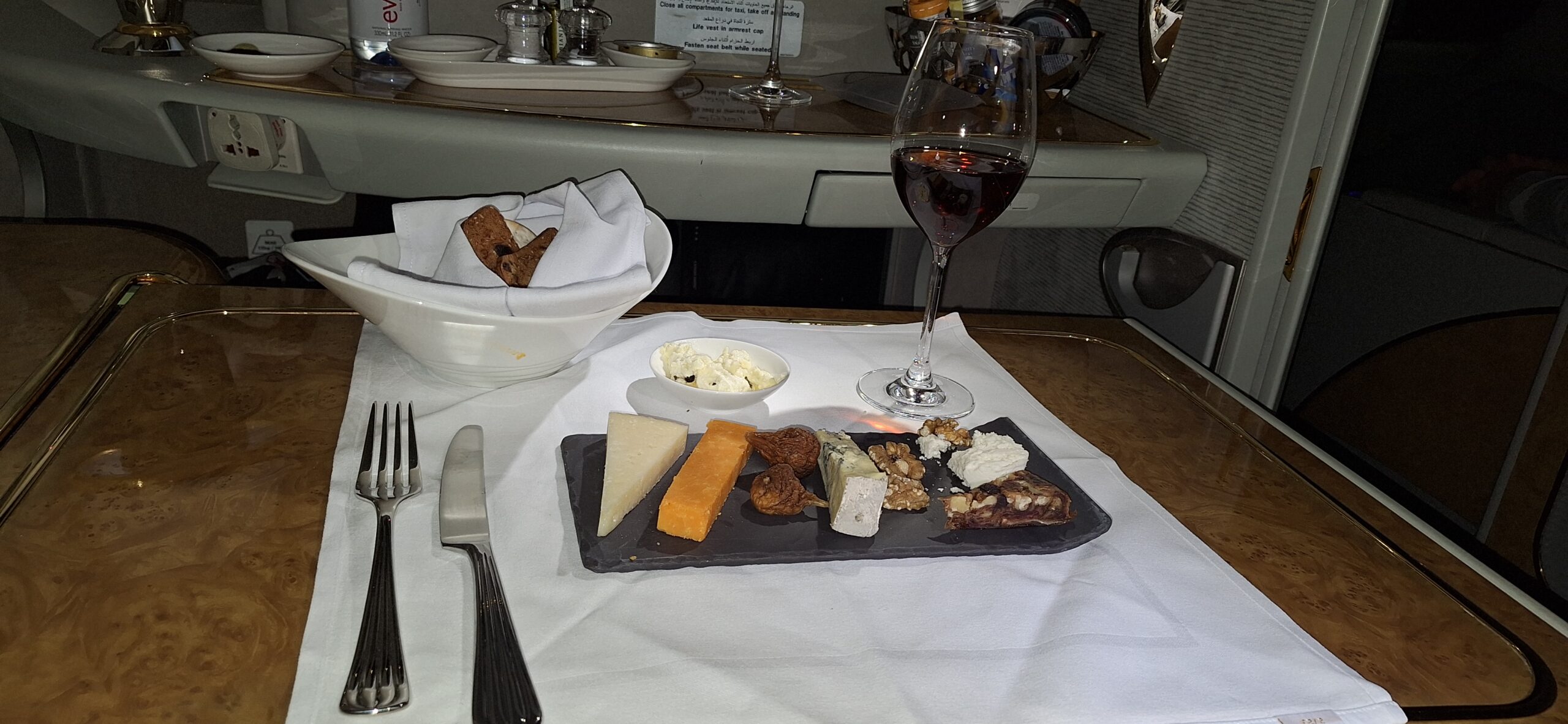 a plate of cheese and a glass of wine