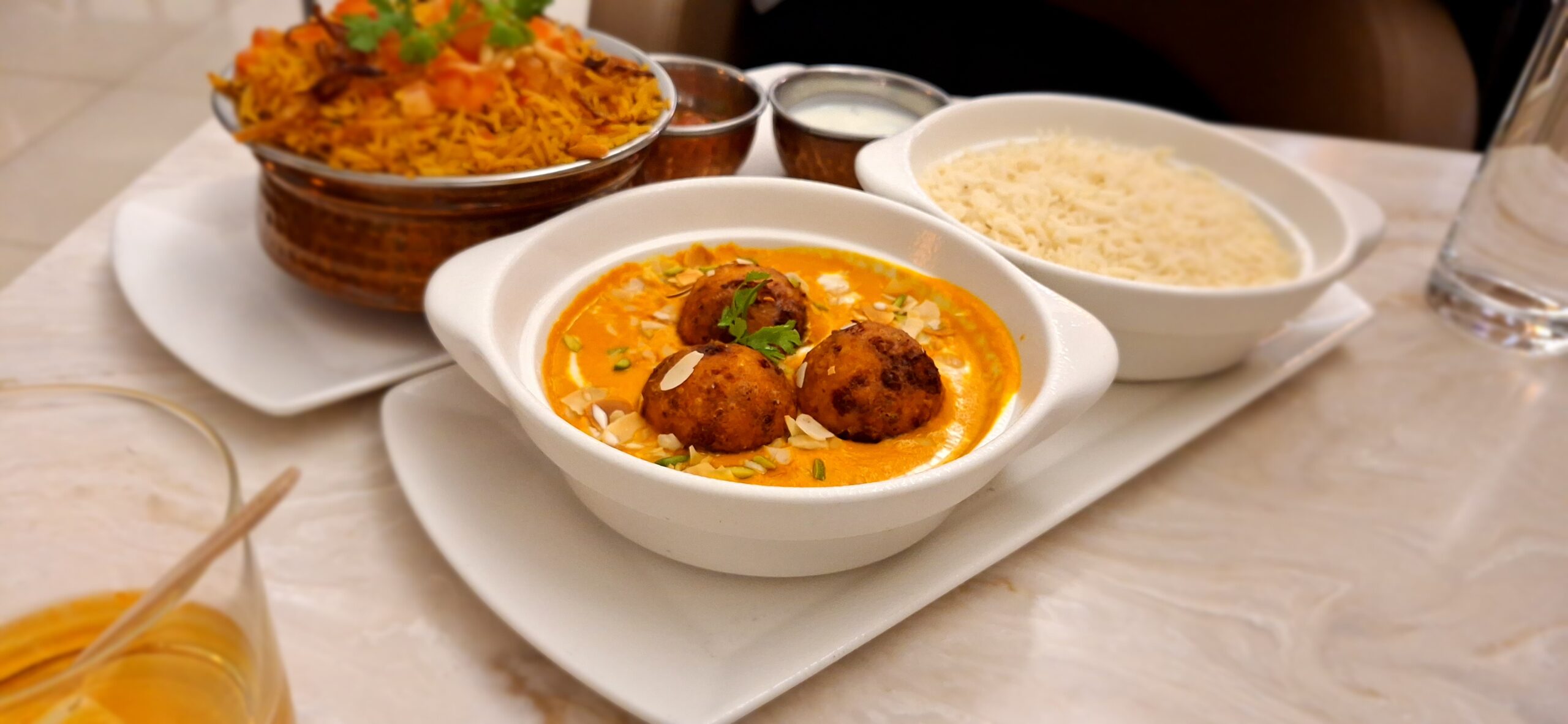 a bowl of food with rice and meatballs