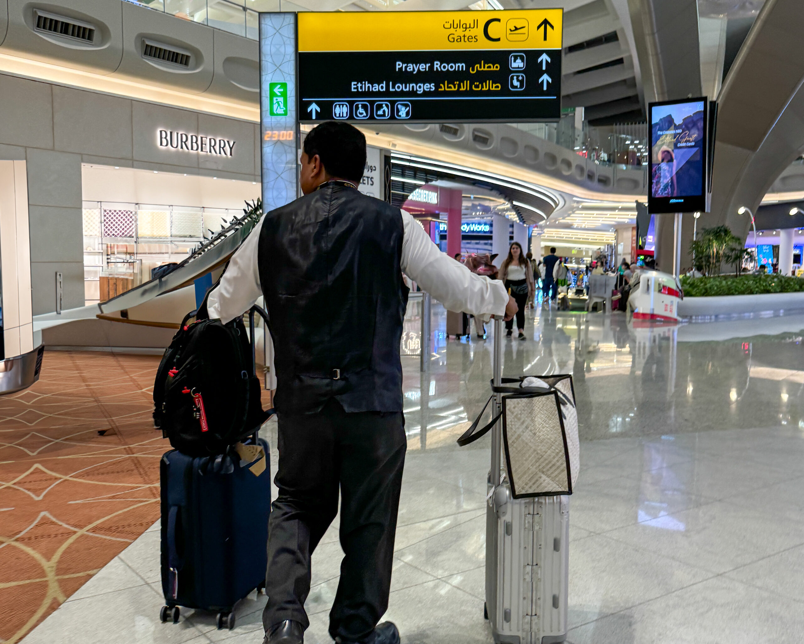 a man standing in a airport with luggage