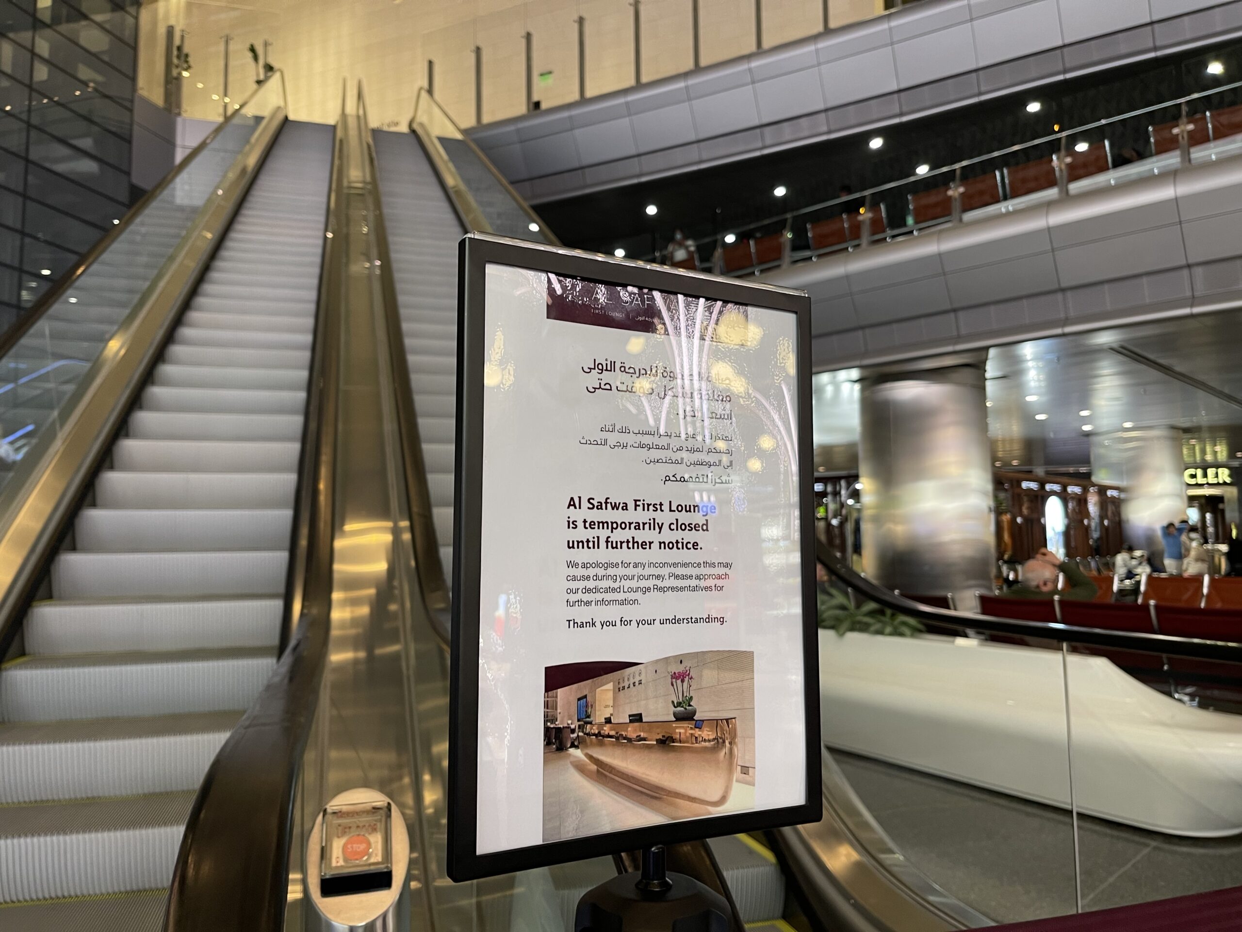 a sign on a escalator