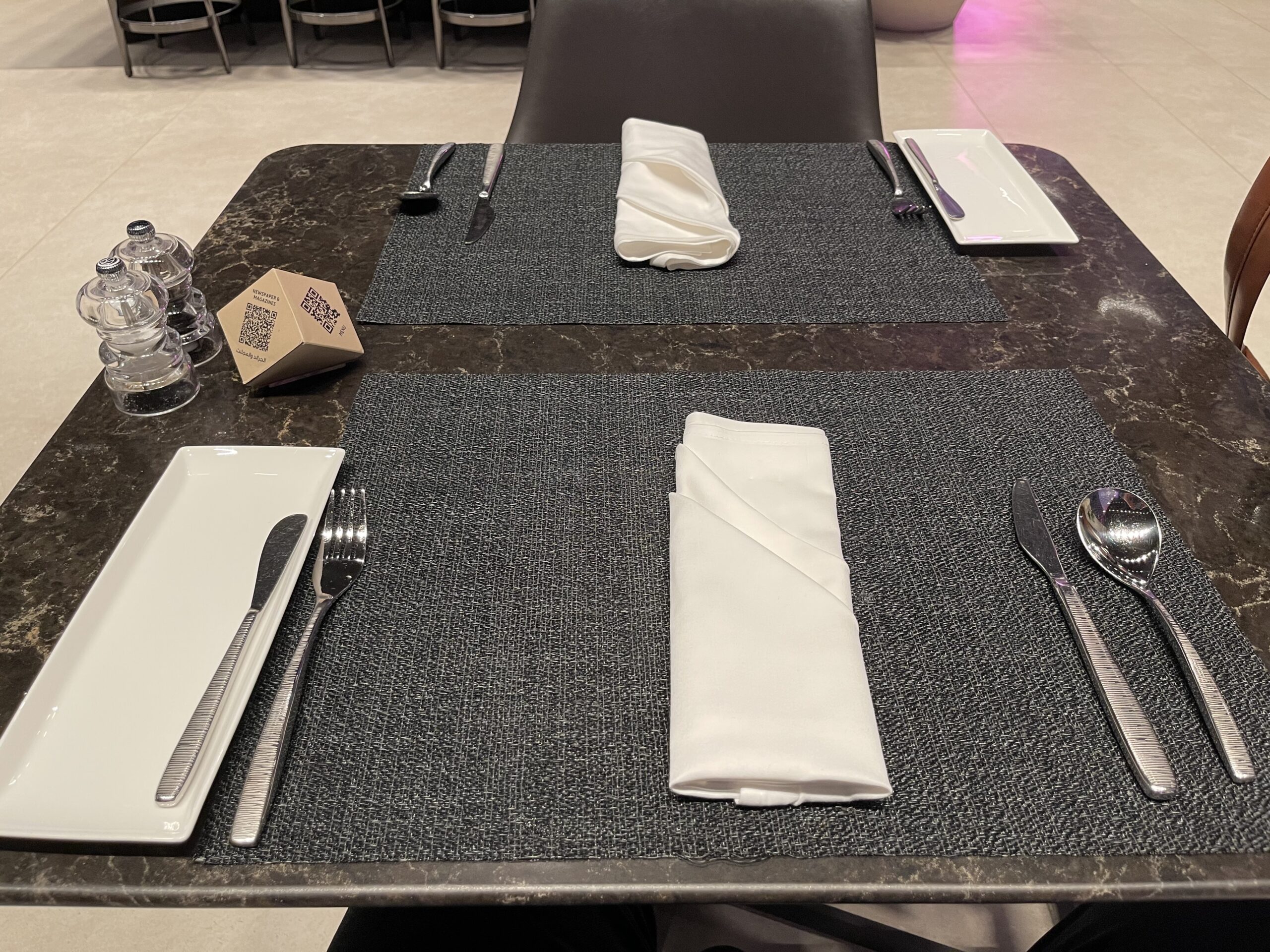 a table with silverware and napkins