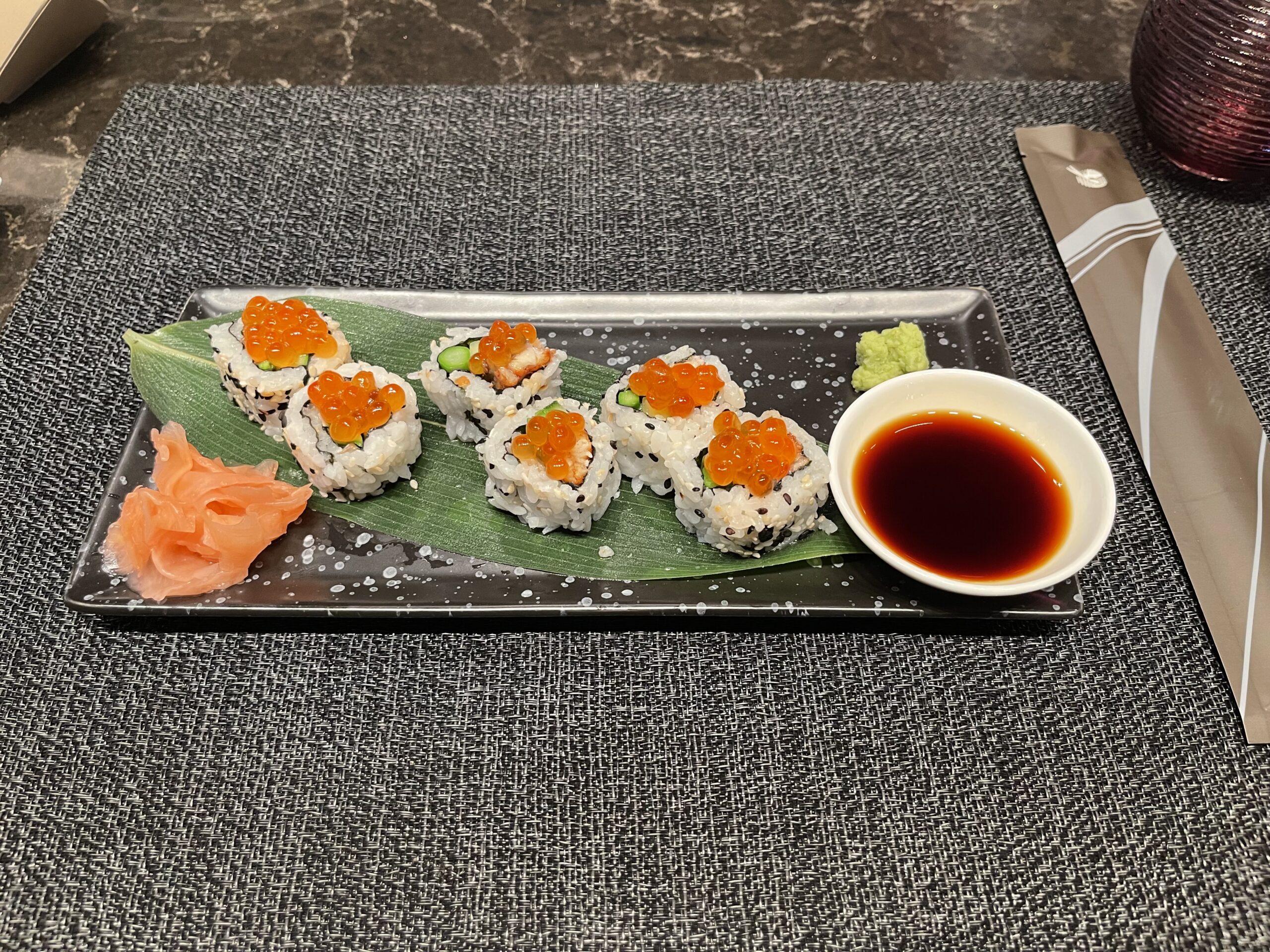 a plate of sushi with sauce