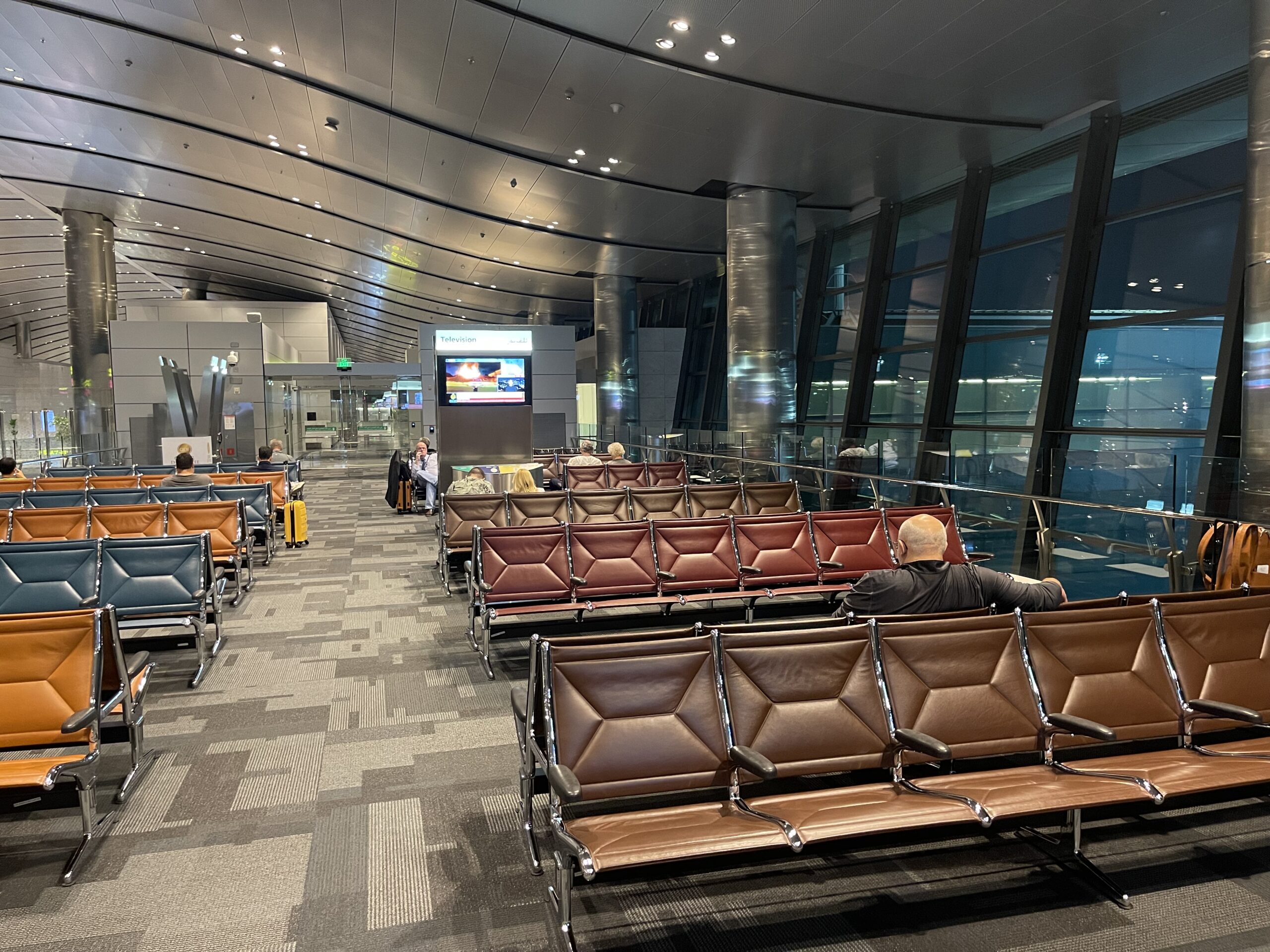 a group of people sitting in chairs in an airport