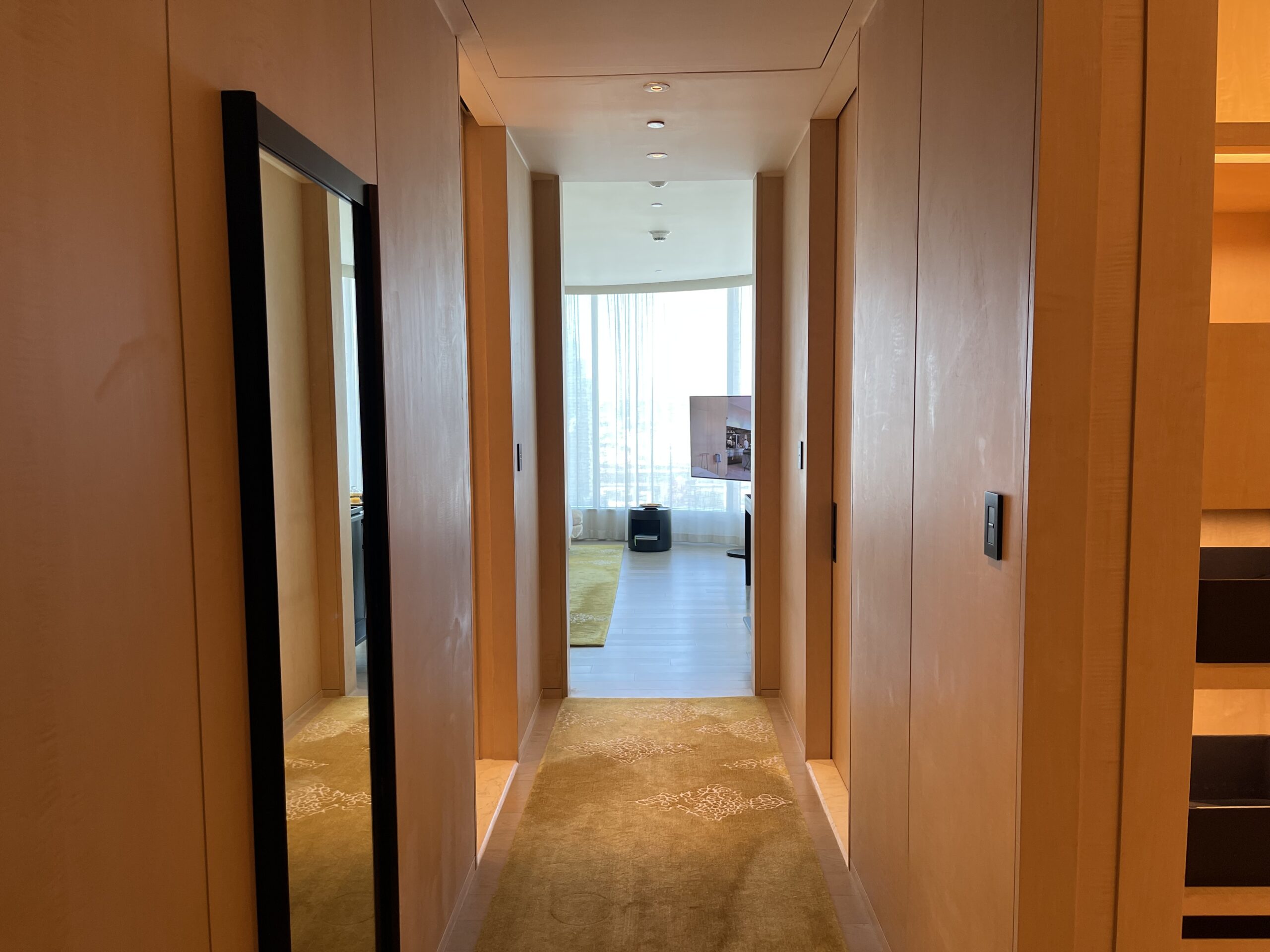 a hallway with mirrors and carpet