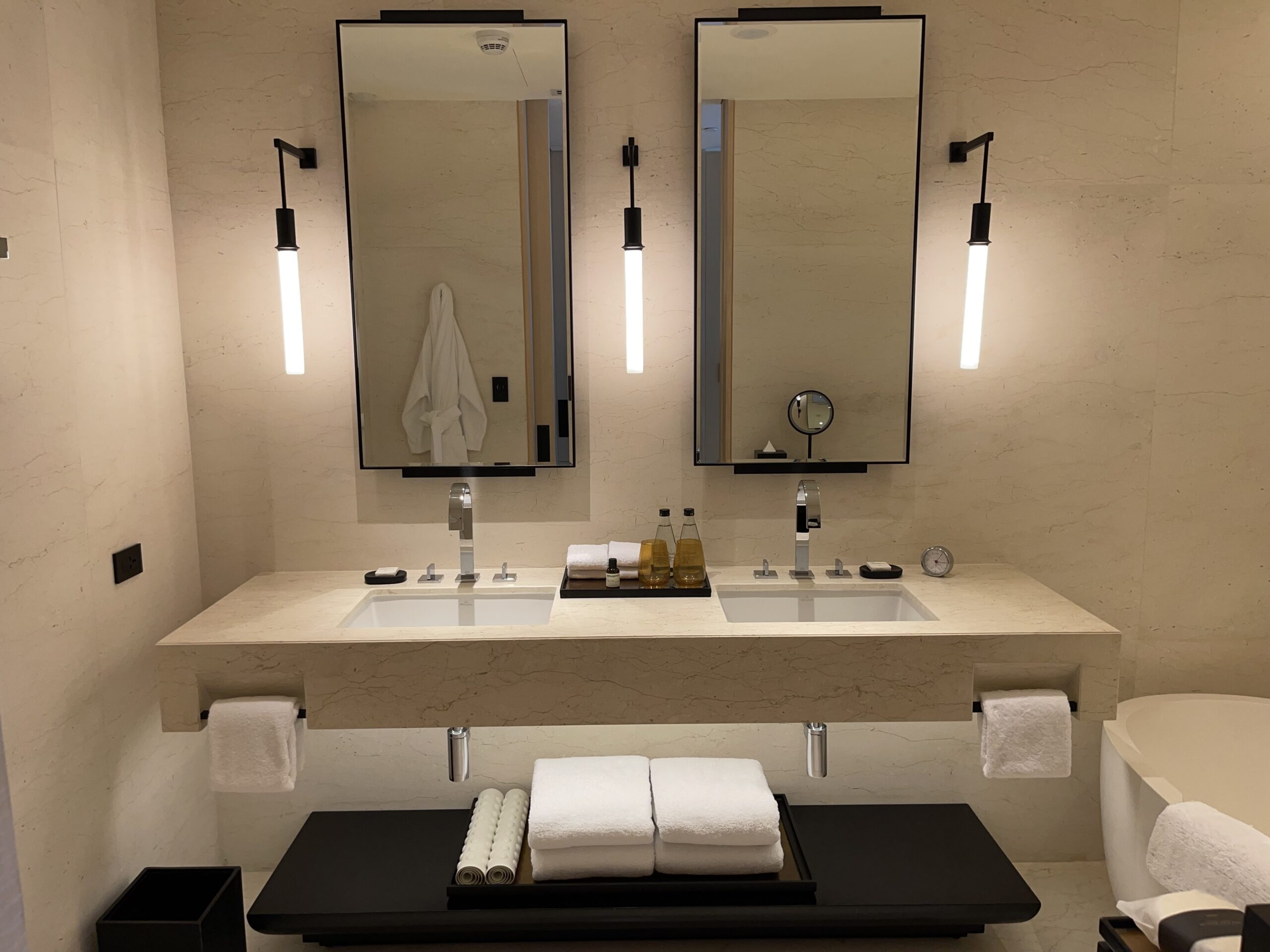 a bathroom with two mirrors and two sinks