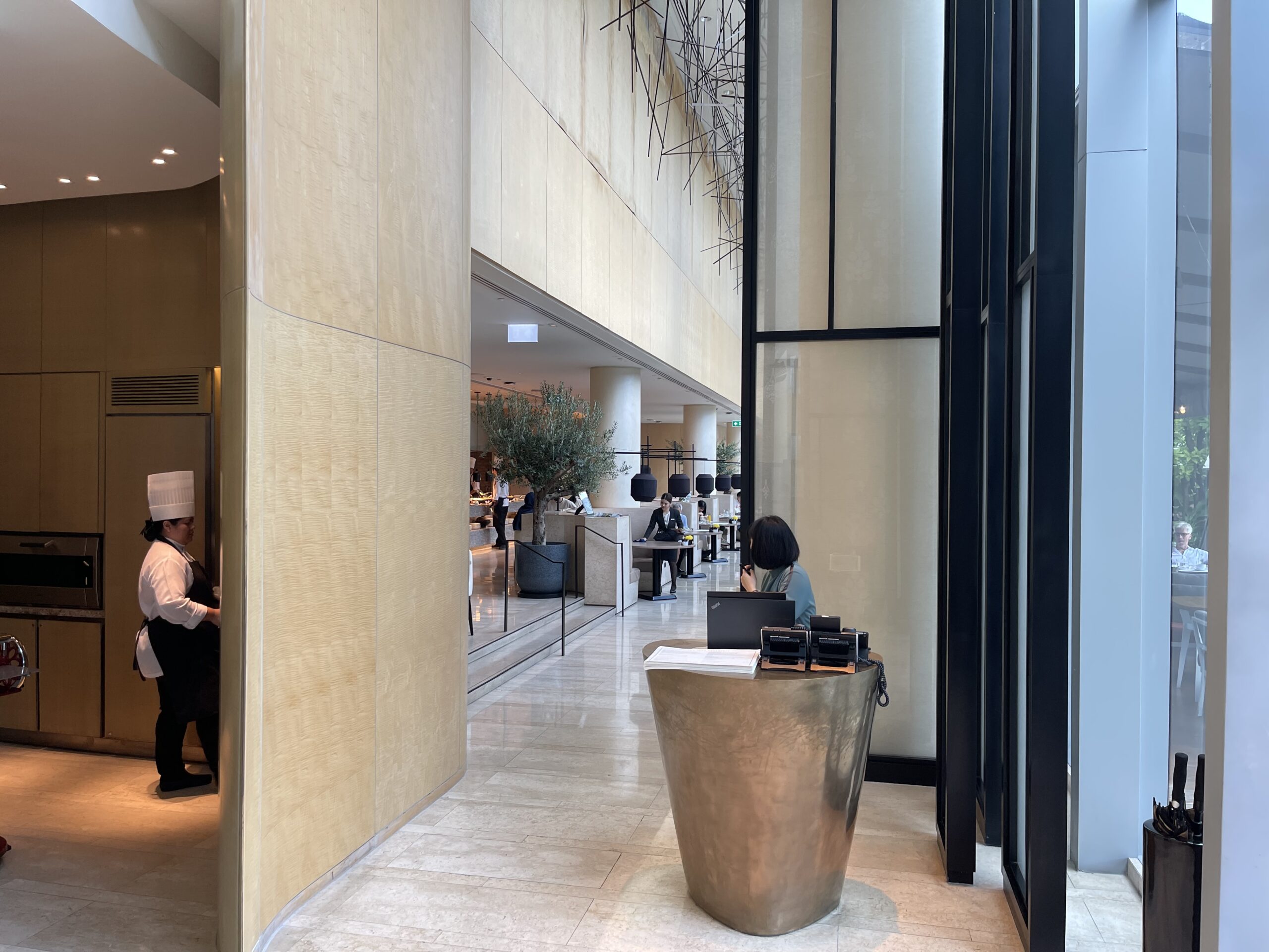 a lobby with a desk and people in the background