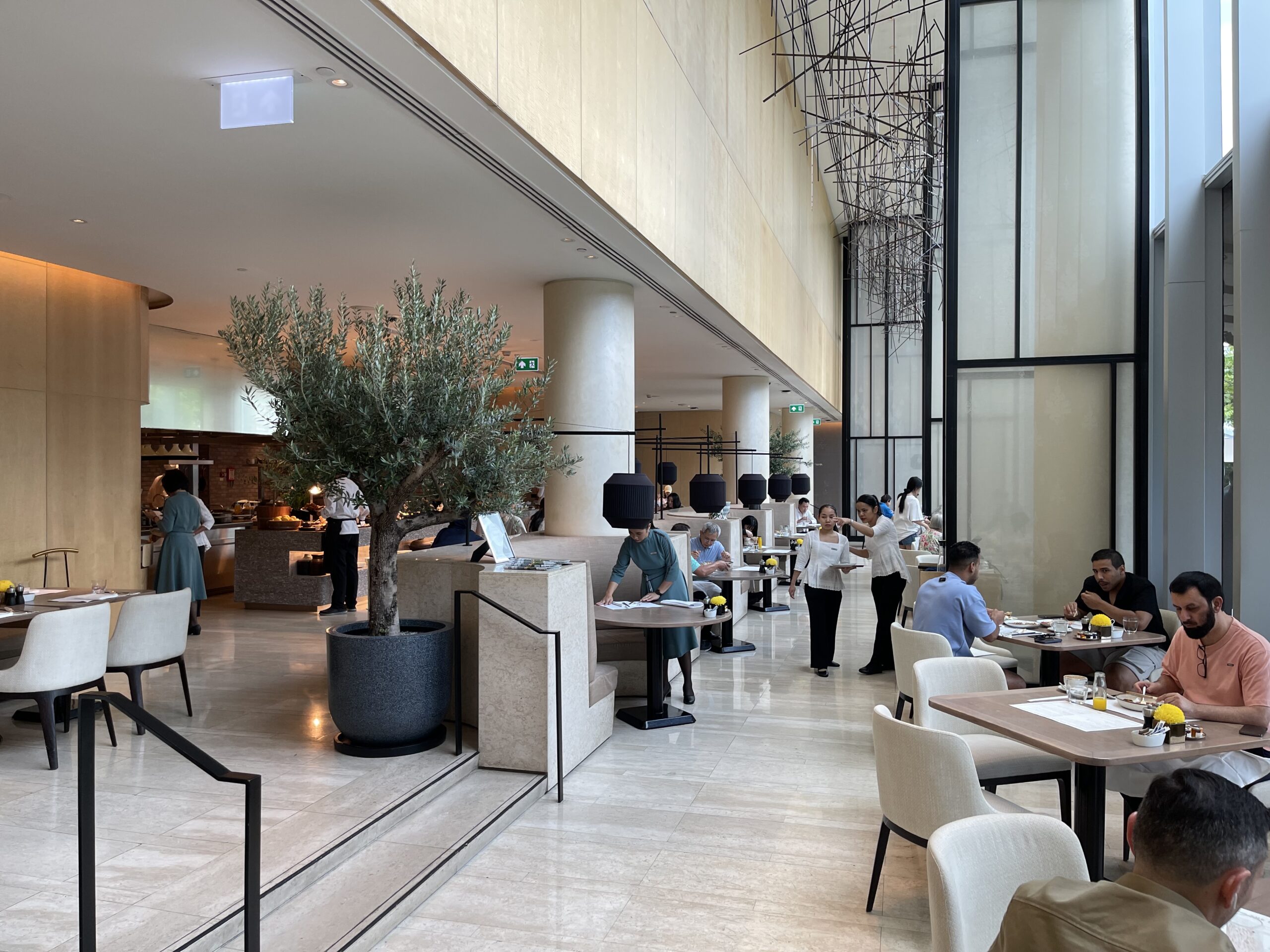 people sitting at tables in a restaurant