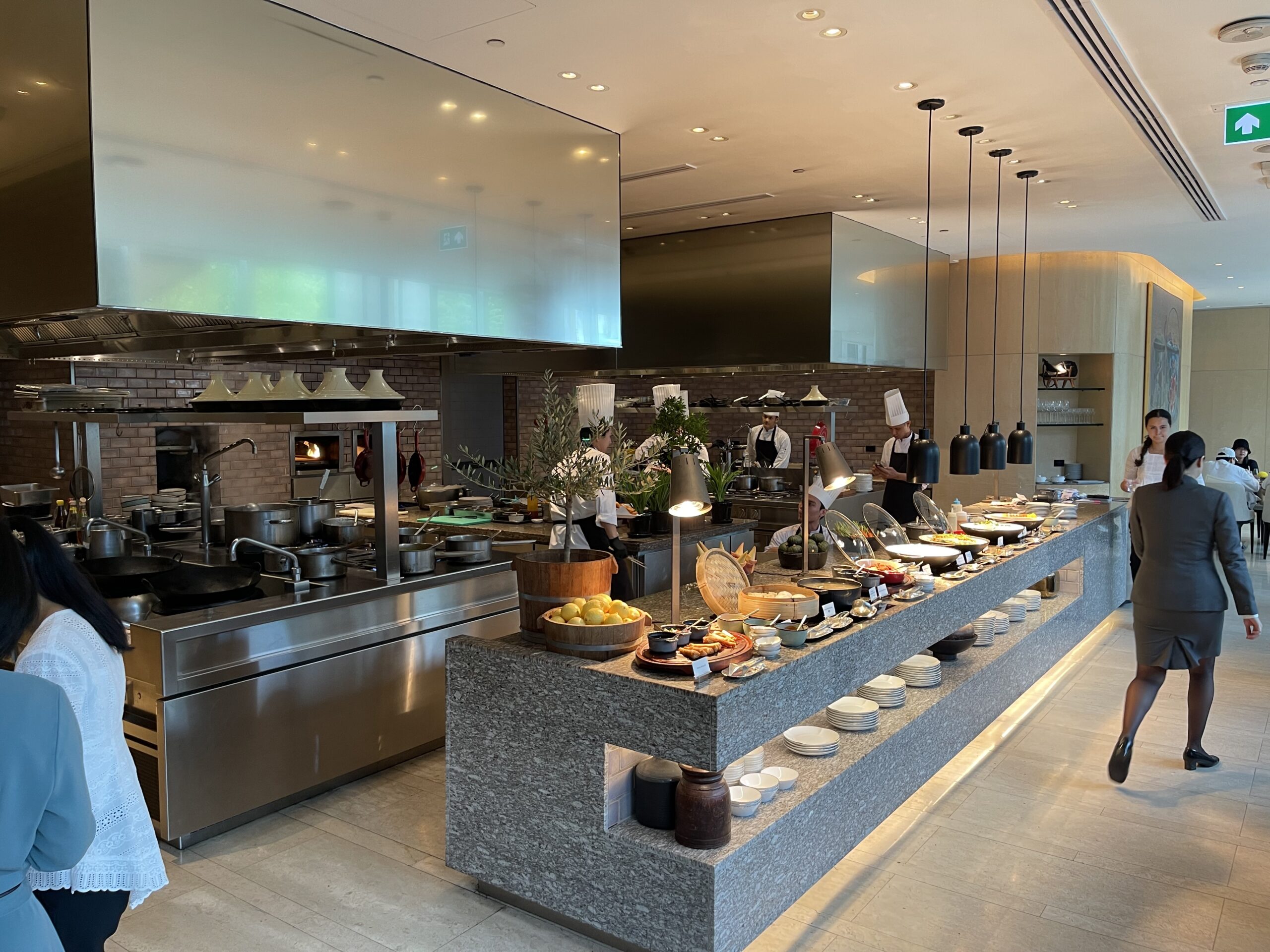 a large kitchen with a large counter with food on it