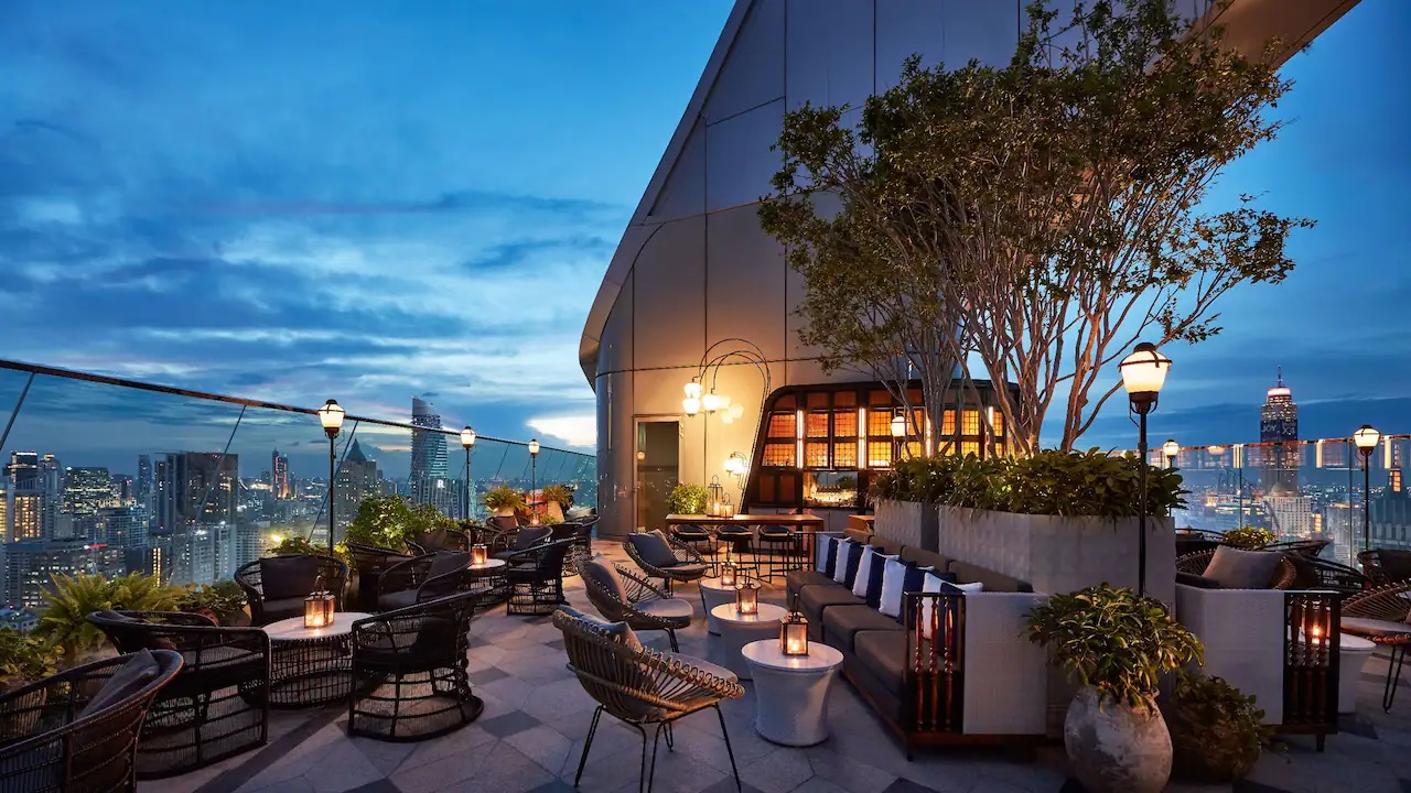 a rooftop patio with chairs and tables