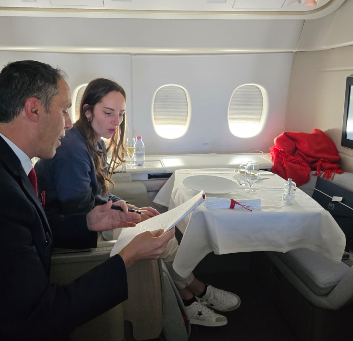 a man and woman sitting in an airplane