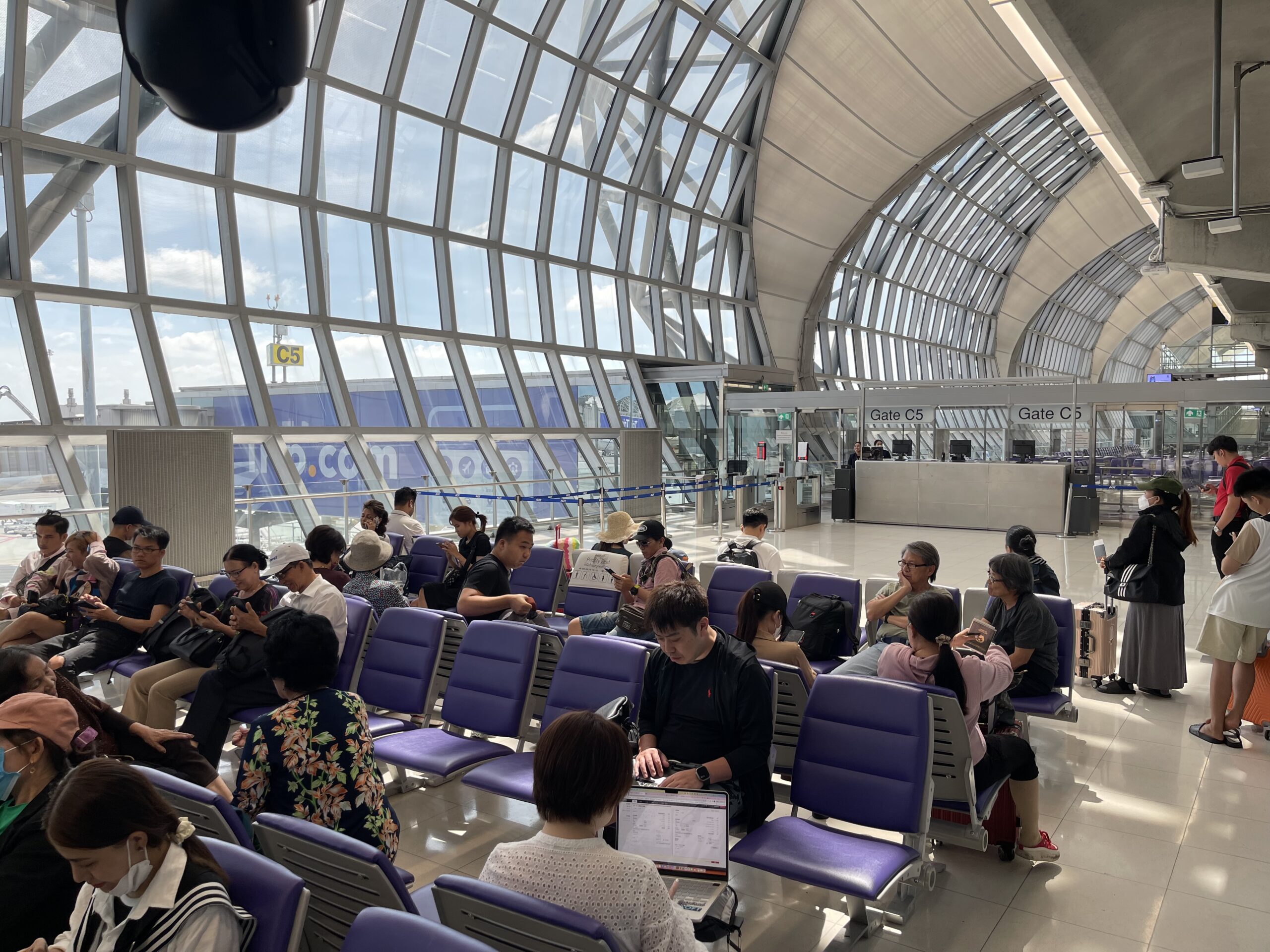 a group of people sitting in chairs in a terminal