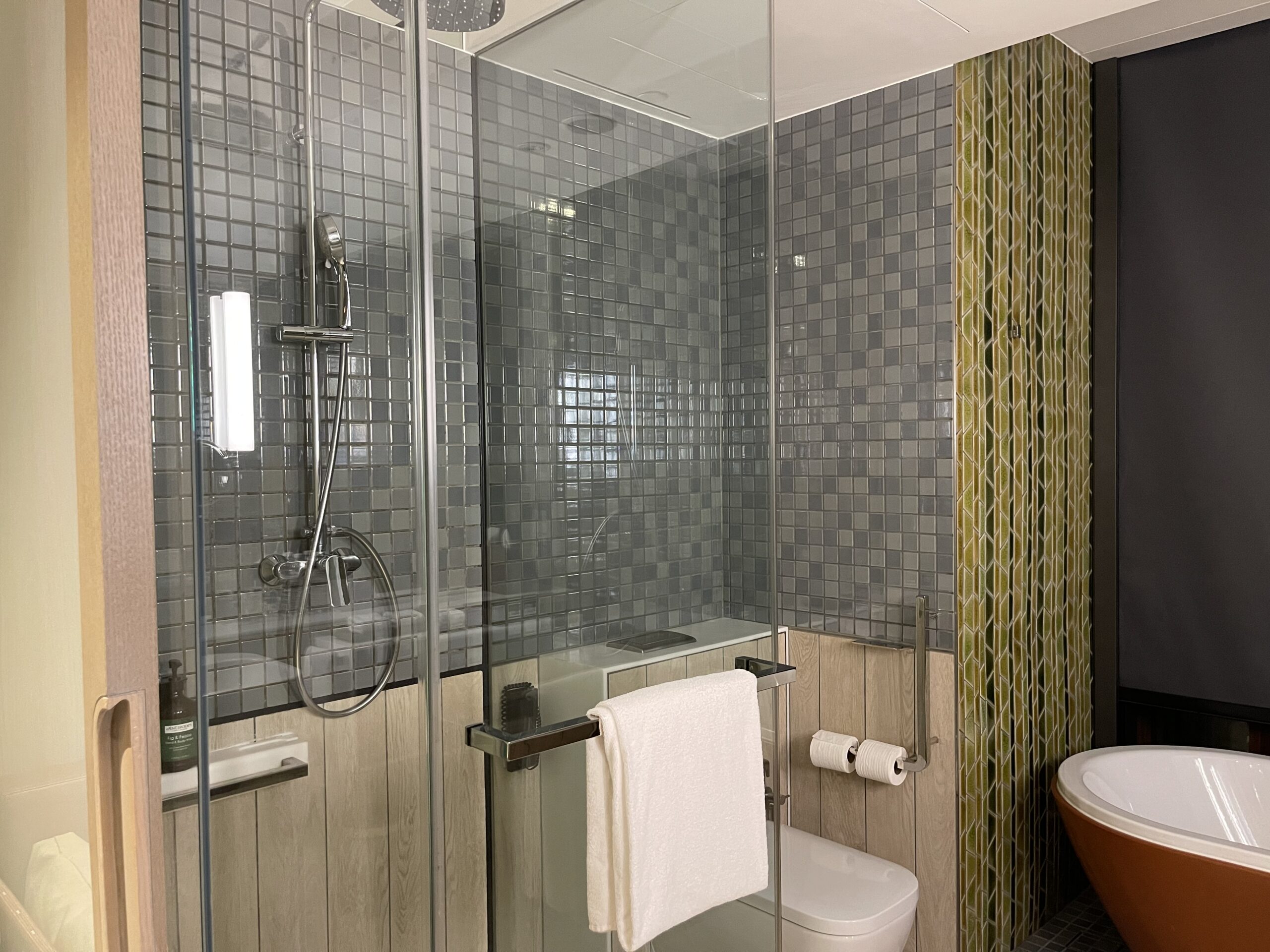 a bathroom with glass shower doors