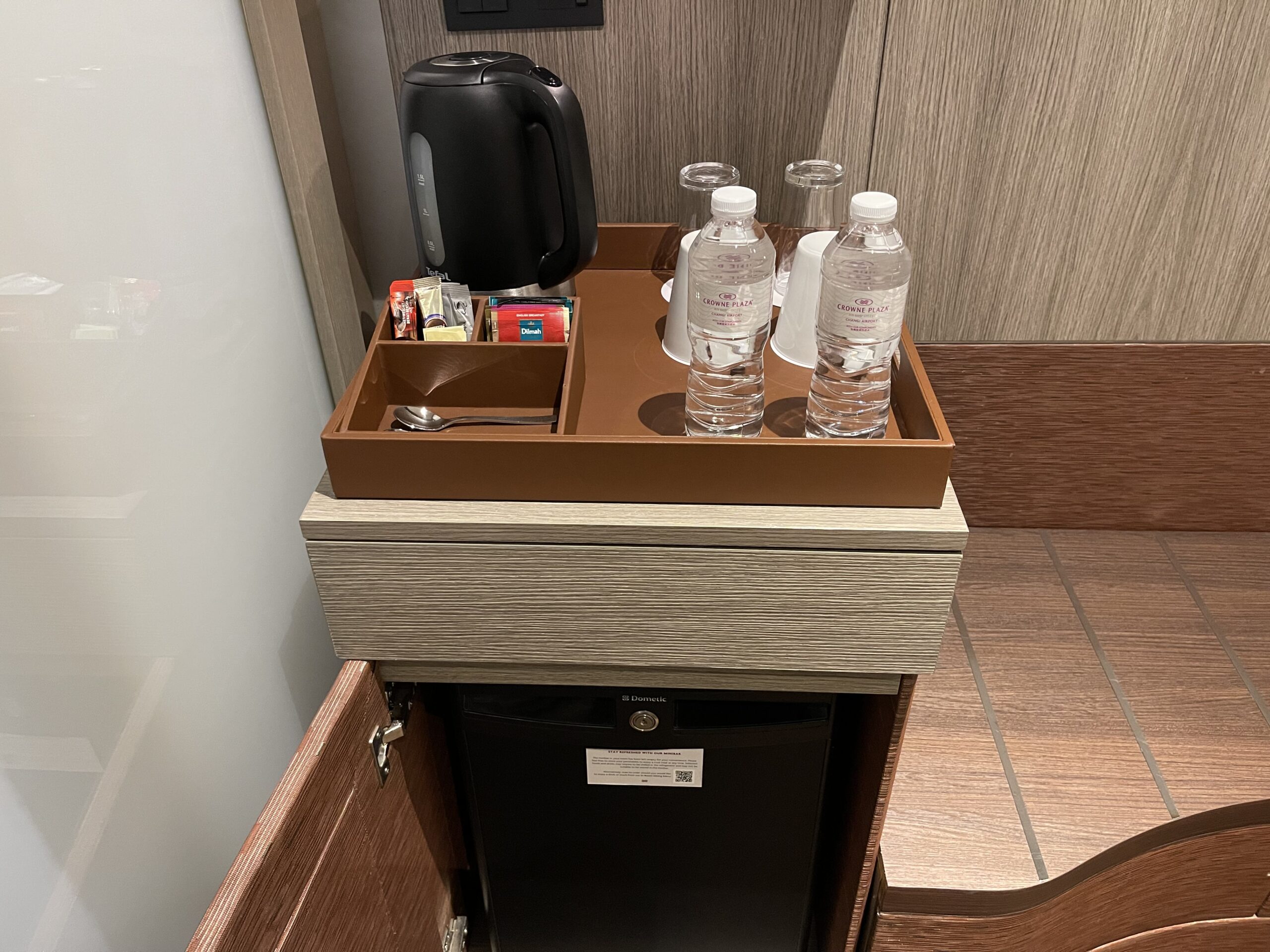 a tray with water bottles and a coffee pot on top of it