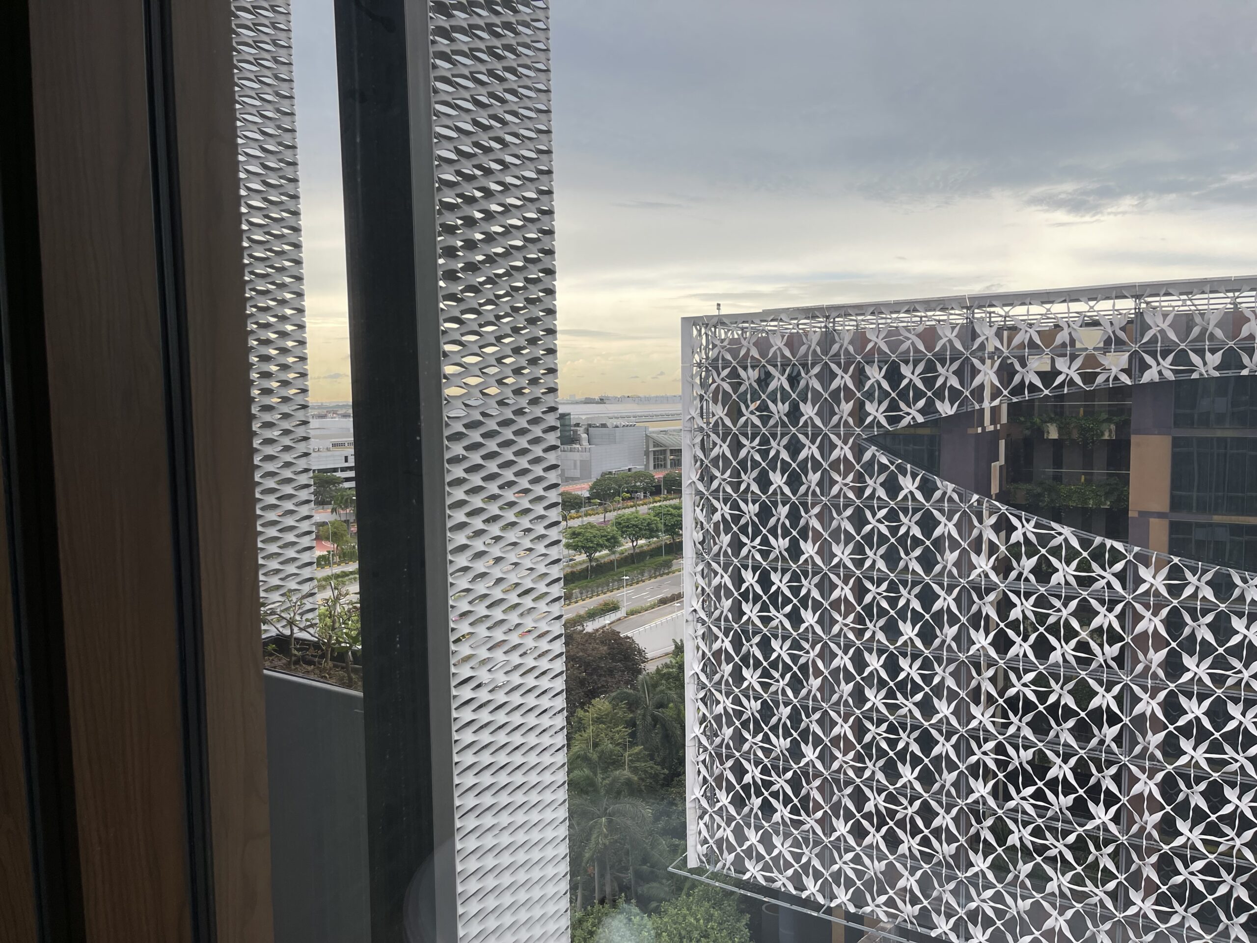 a window with a view of a city and a road