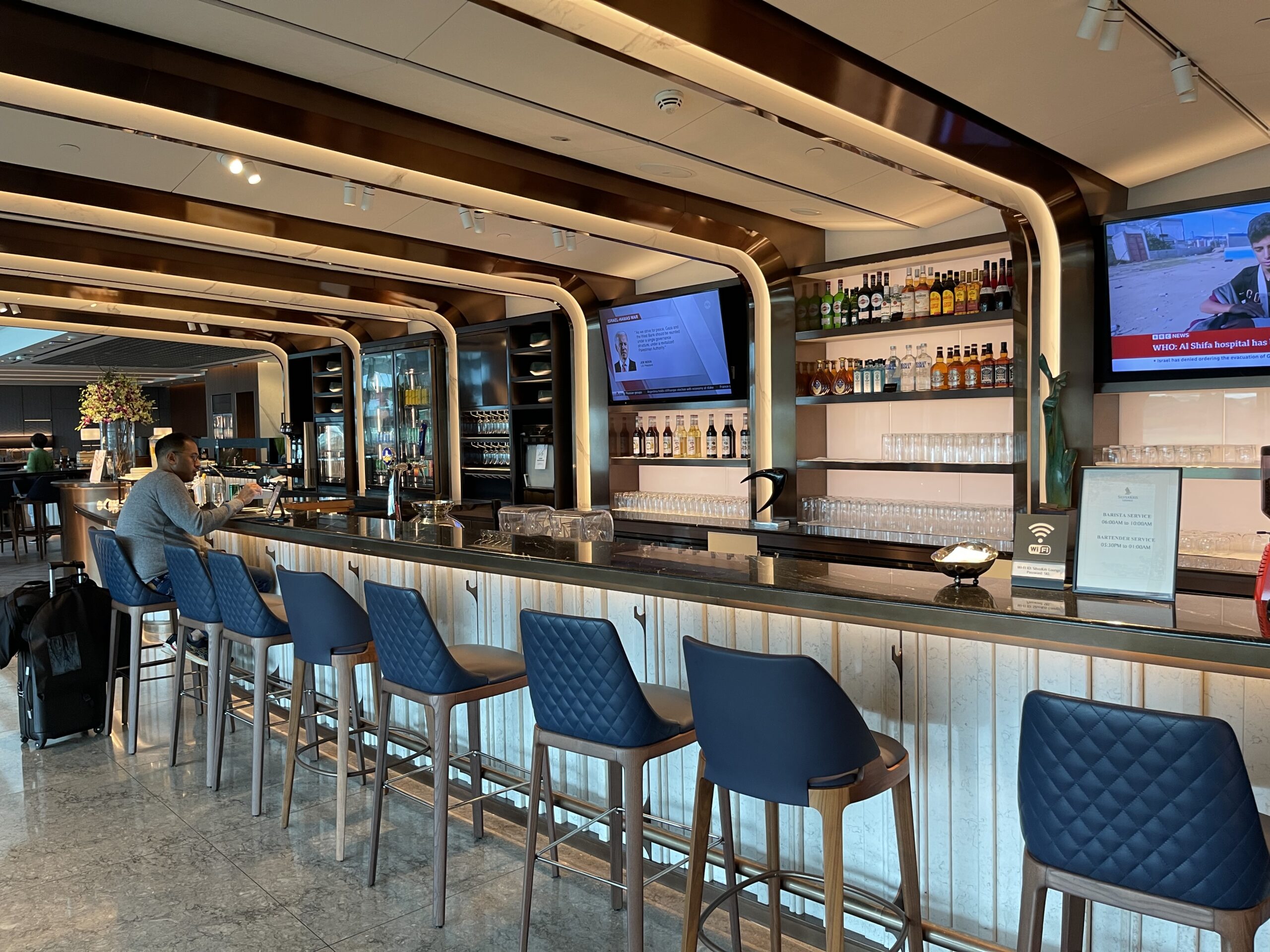 a bar with a man standing behind a bar