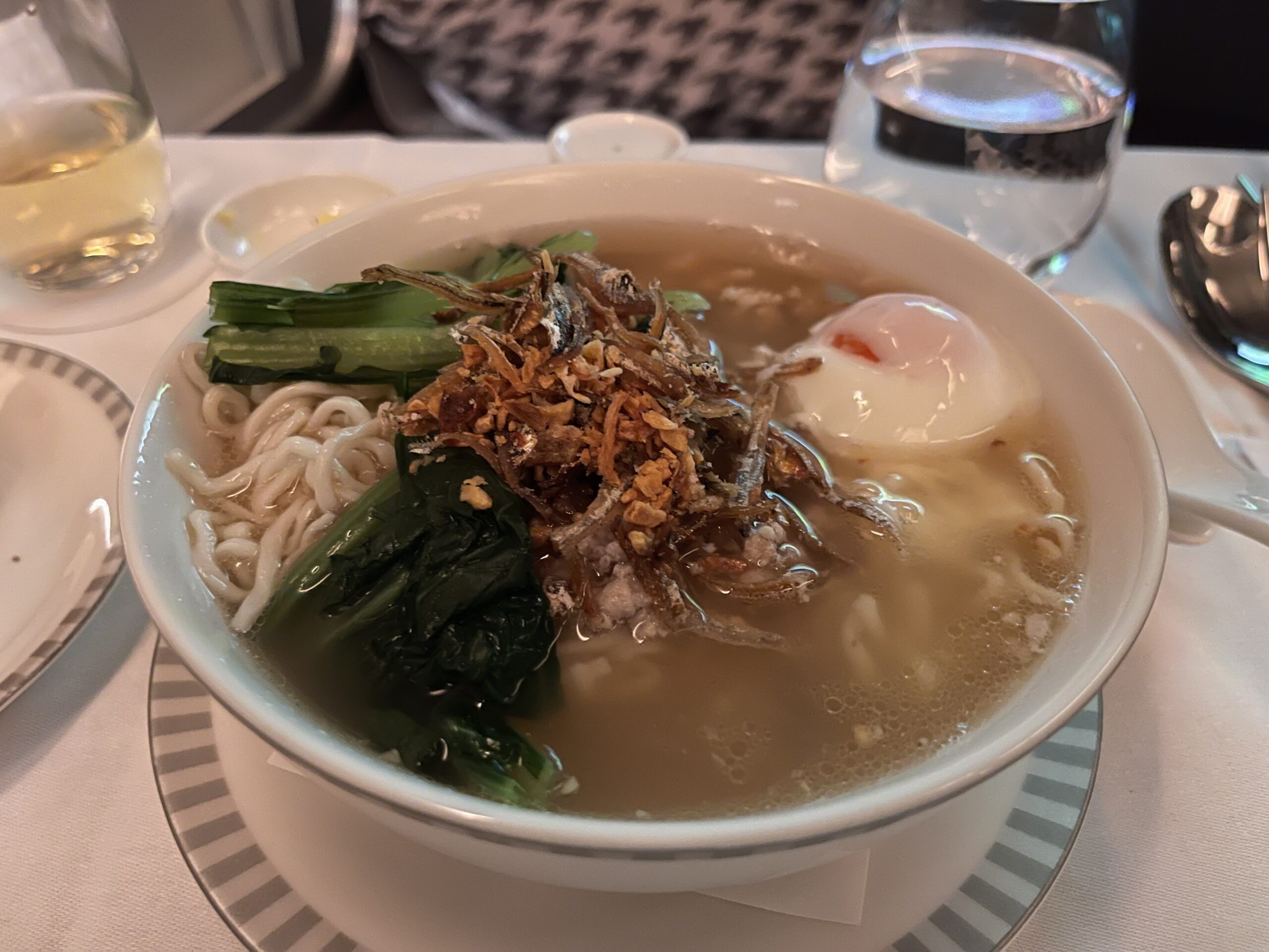 a bowl of soup with vegetables and noodles