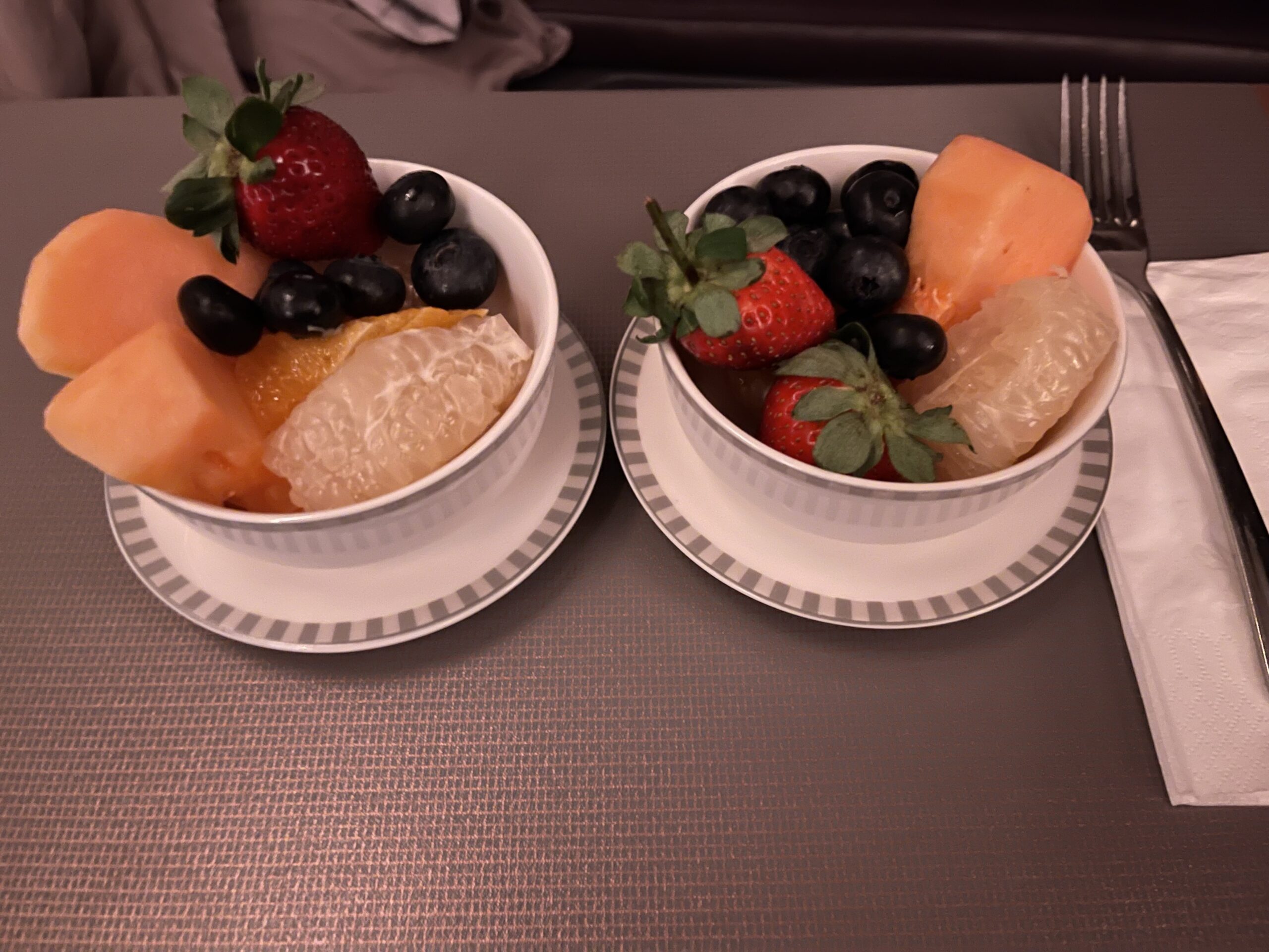 two bowls of fruit on a table