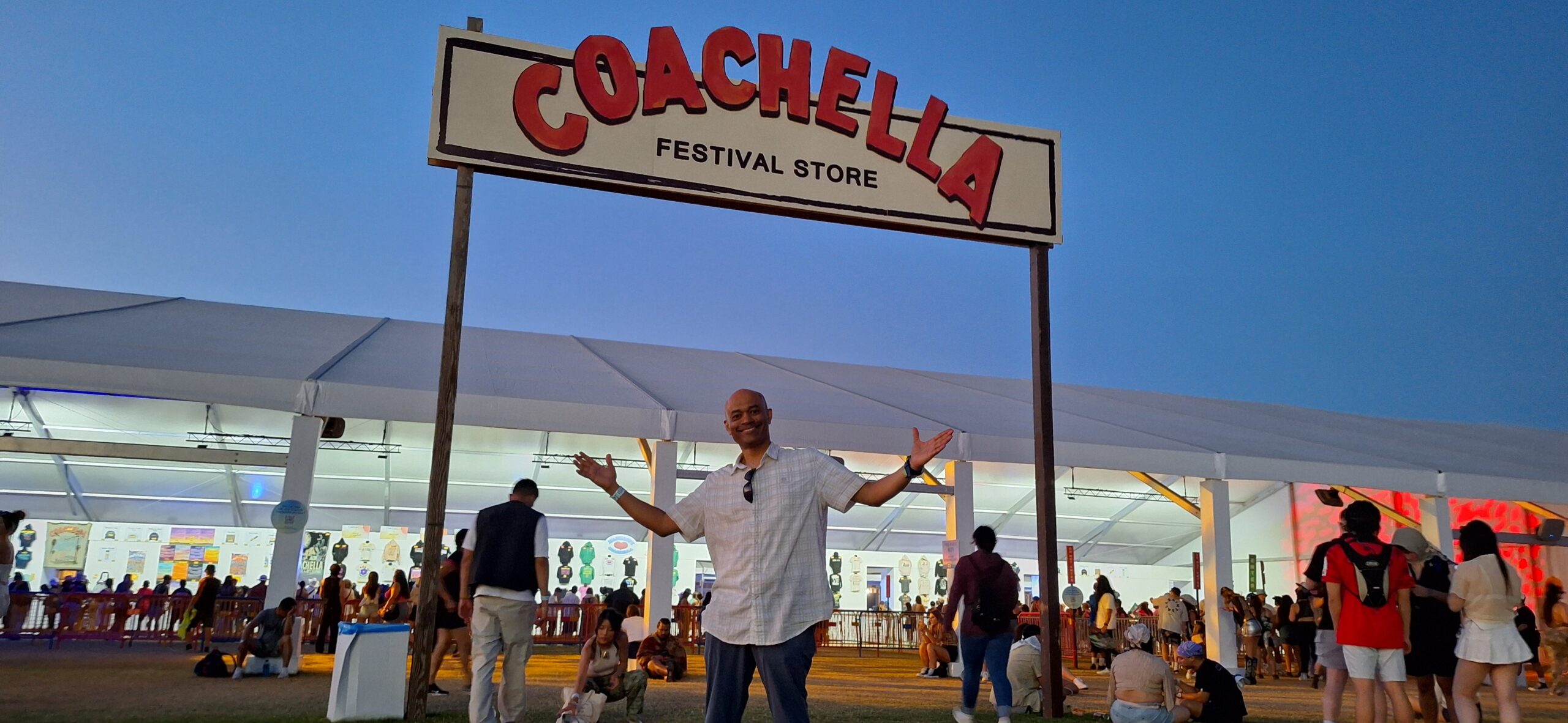 a man standing under a sign