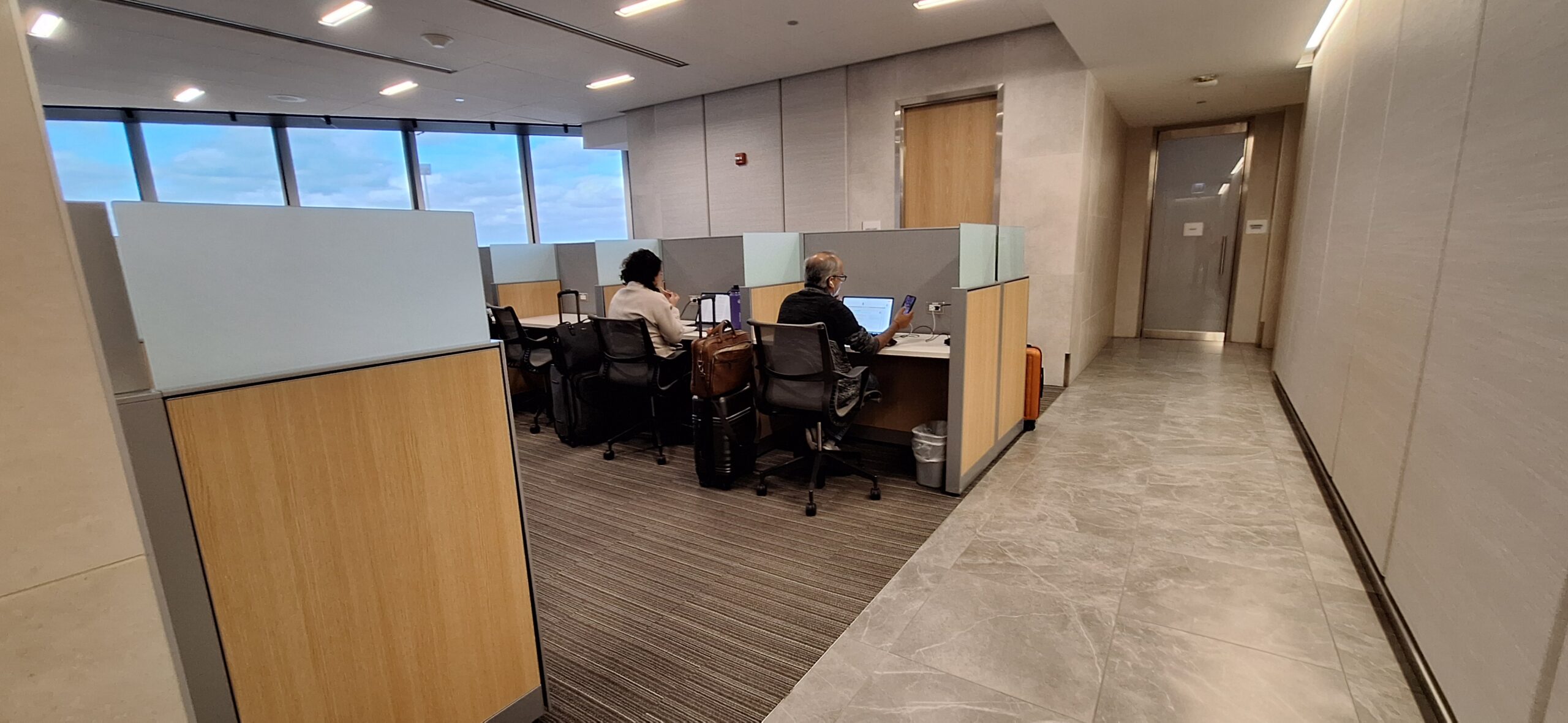 people sitting at a desk in an office