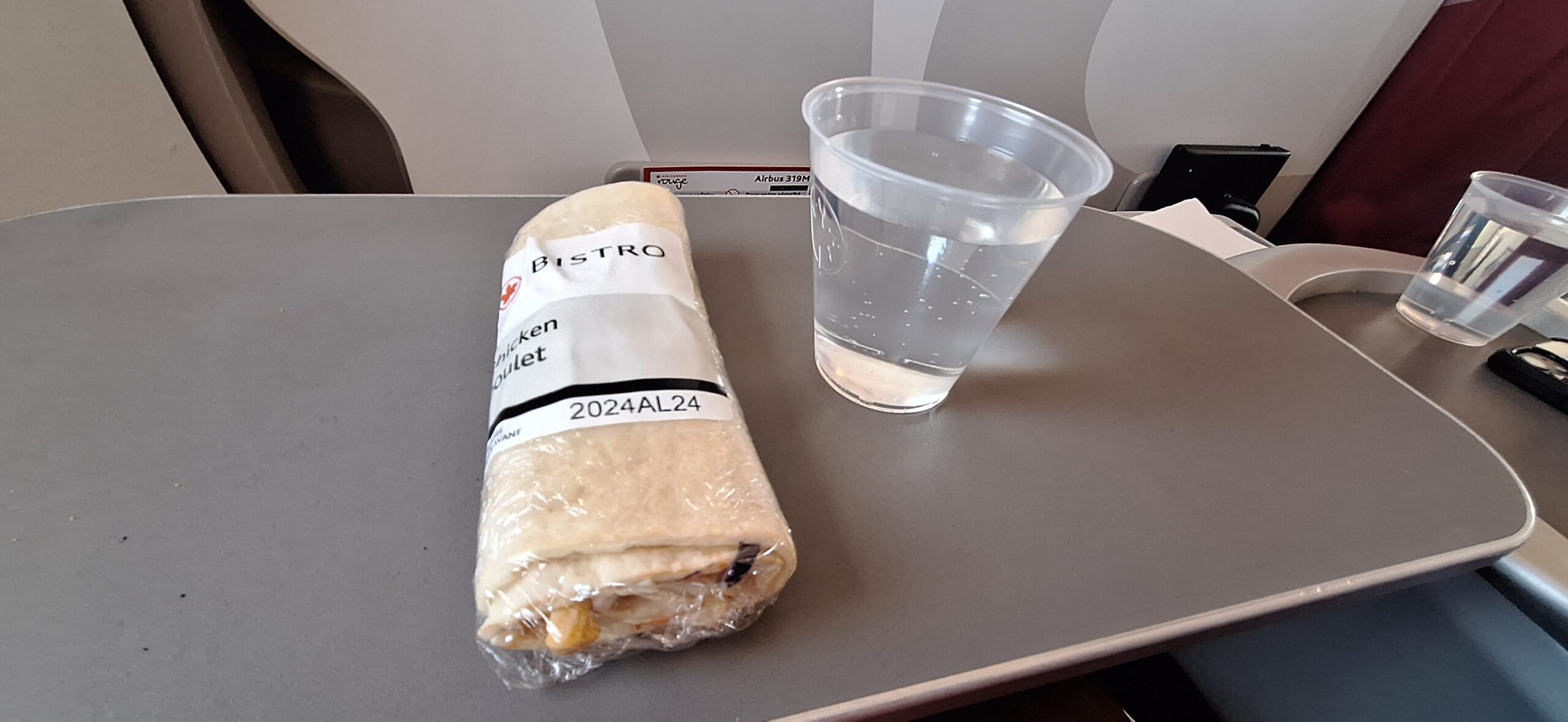 a sandwich and a glass of water on a table