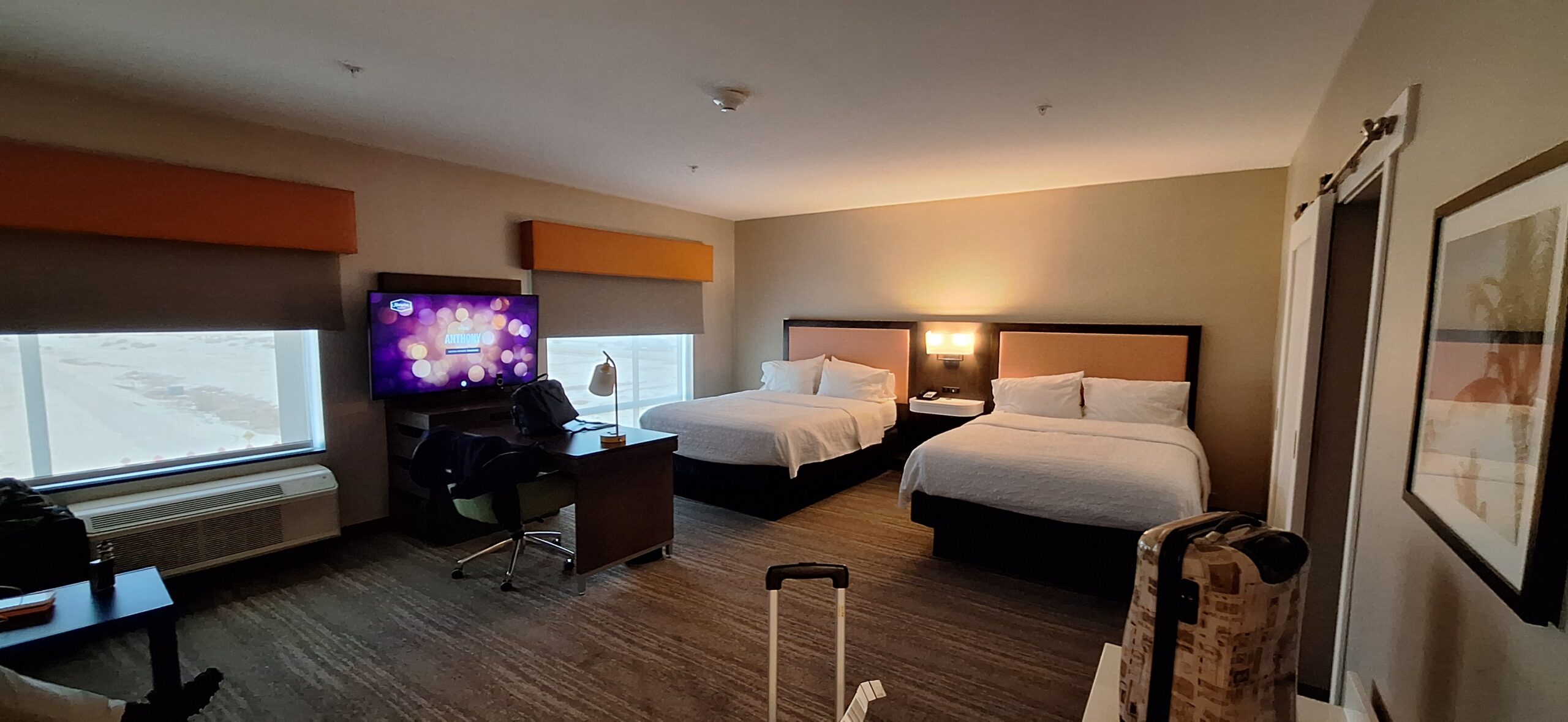 a room with two beds and a television