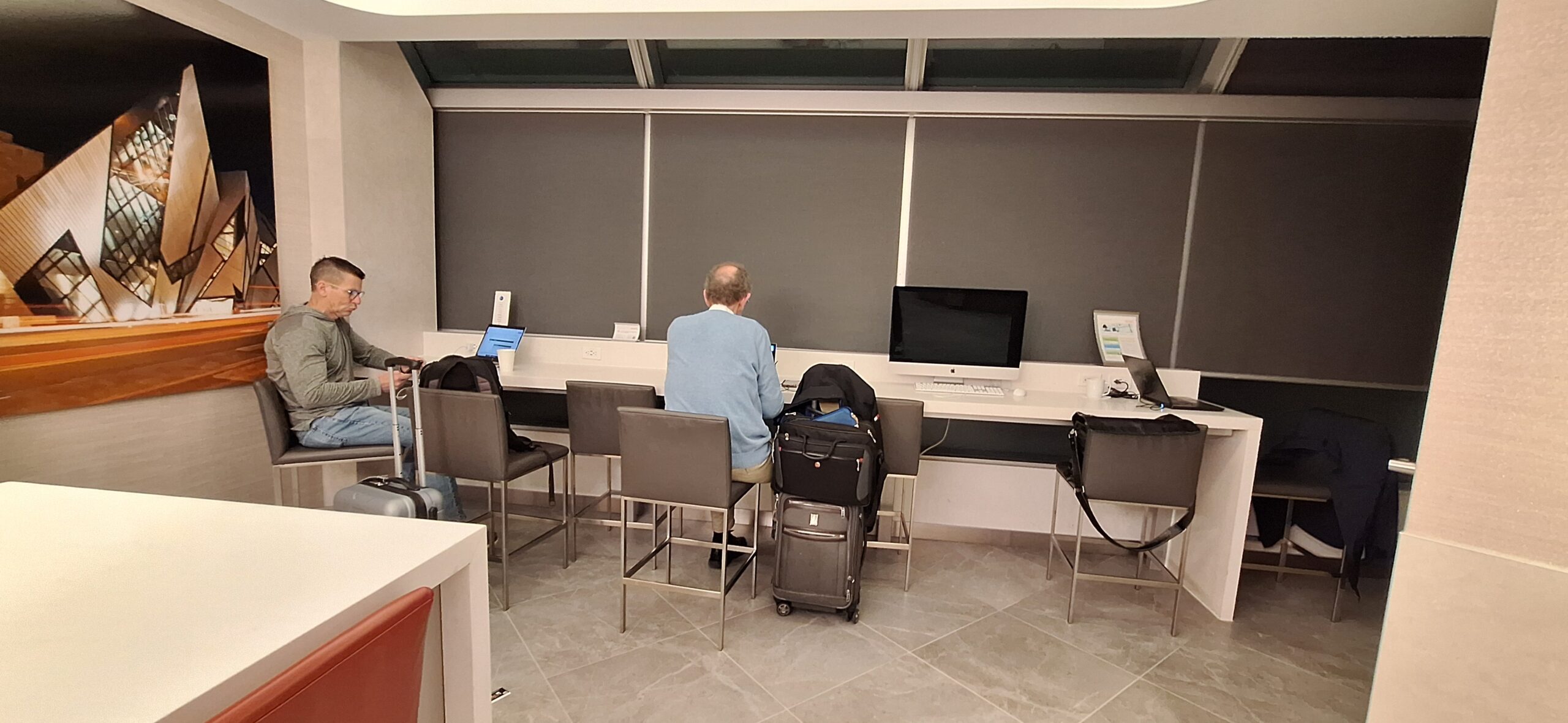 a man sitting at a desk with luggage