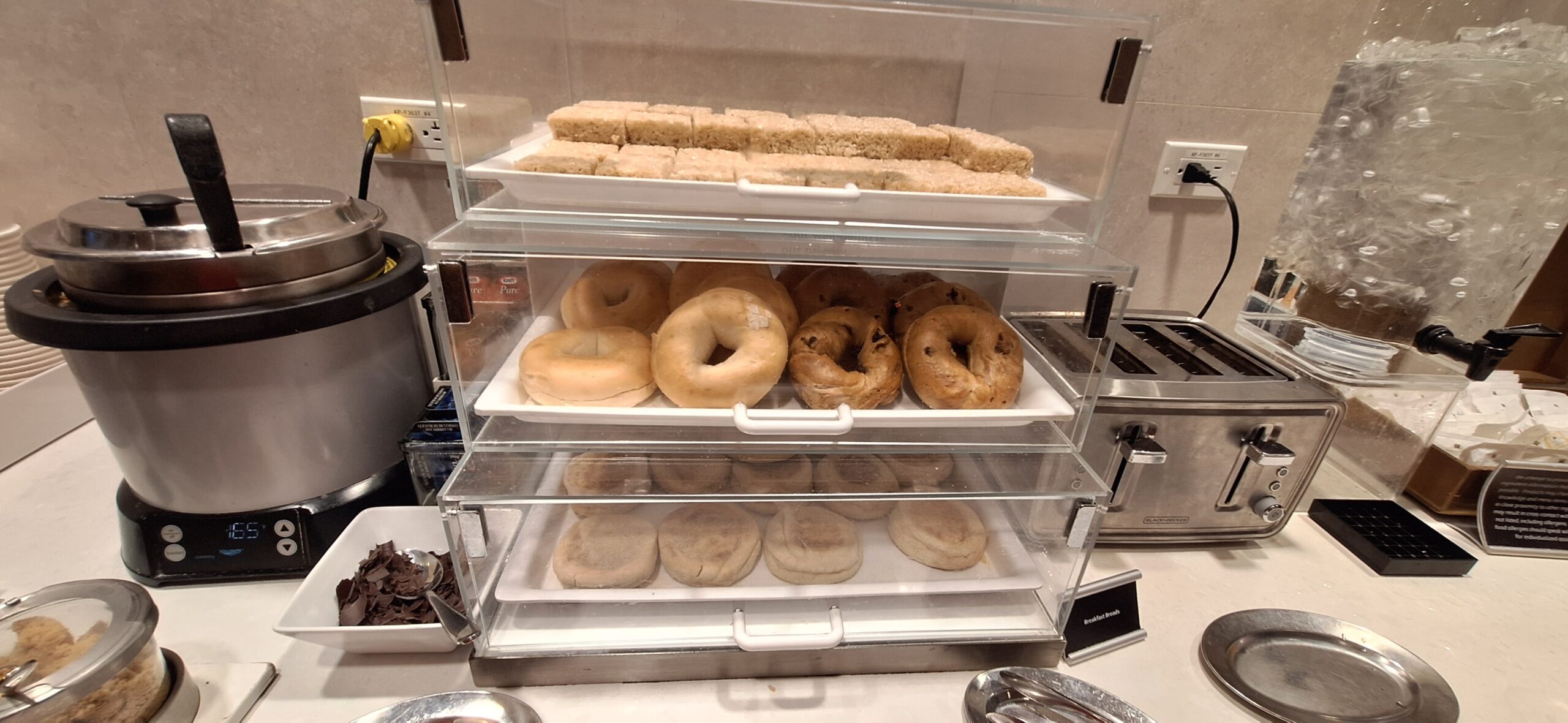 a tray of bagels and pastries on a shelf