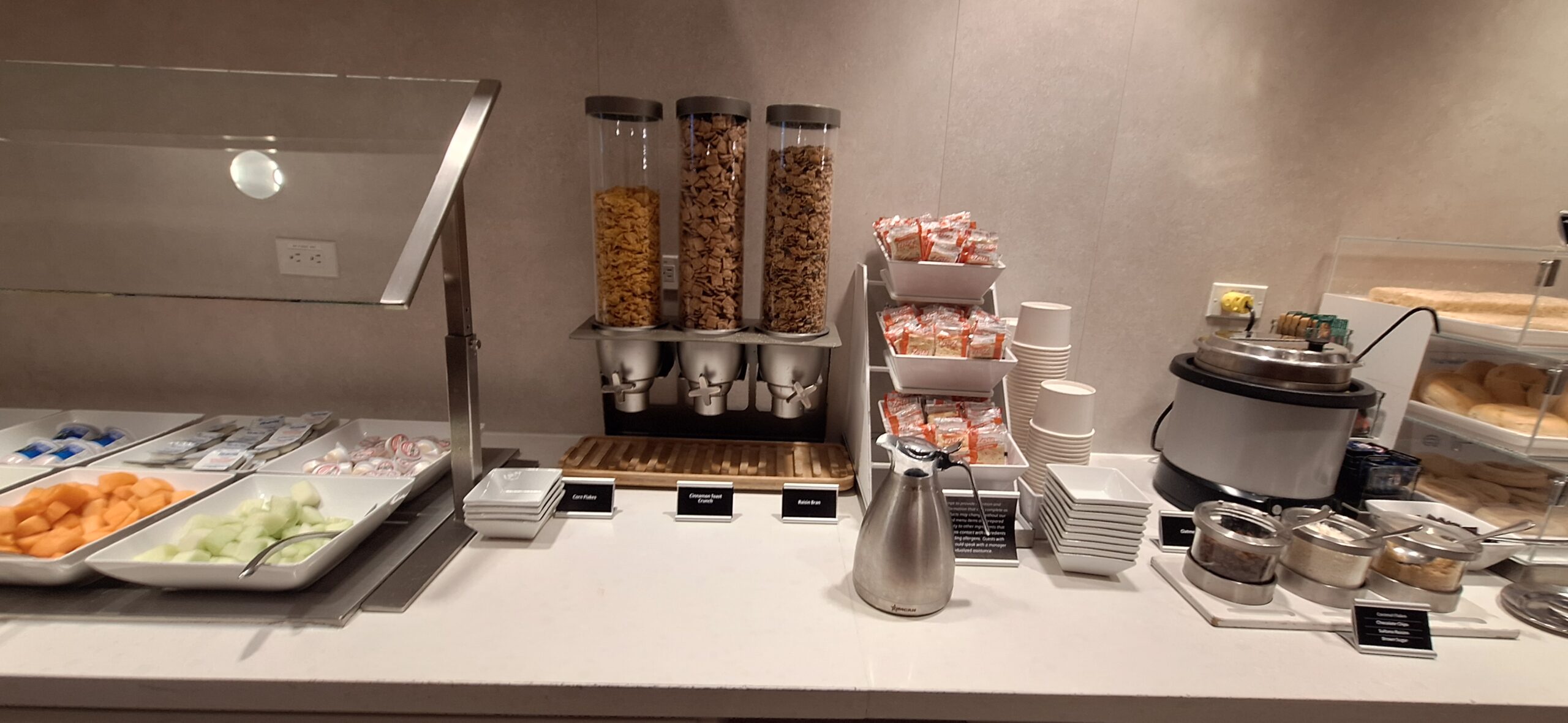 a breakfast buffet with cereal and cereal in containers