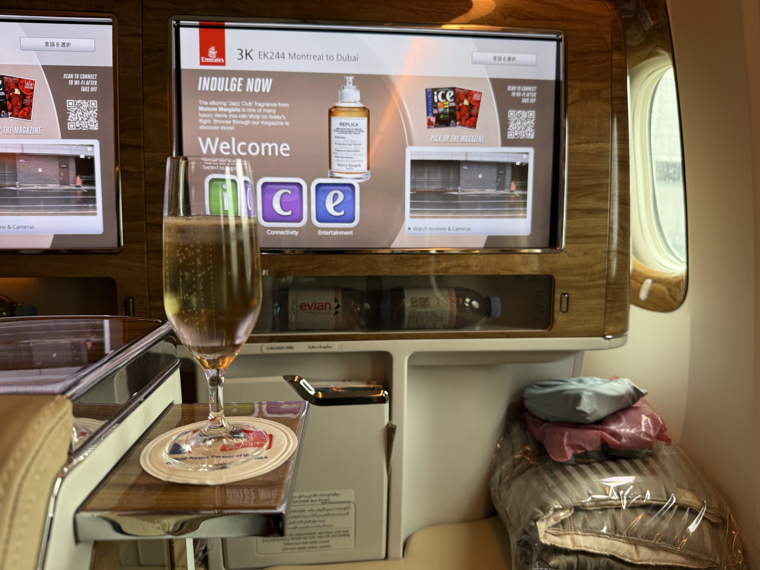 a glass of champagne on a tray in a plane