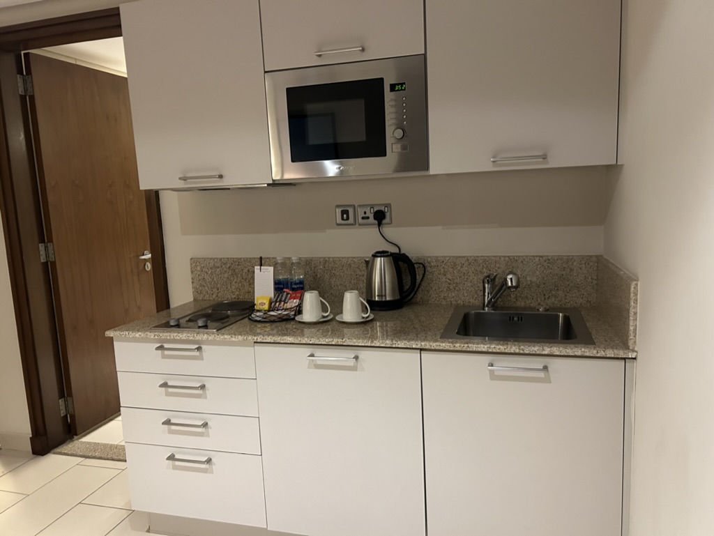 a kitchen with white cabinets and a microwave