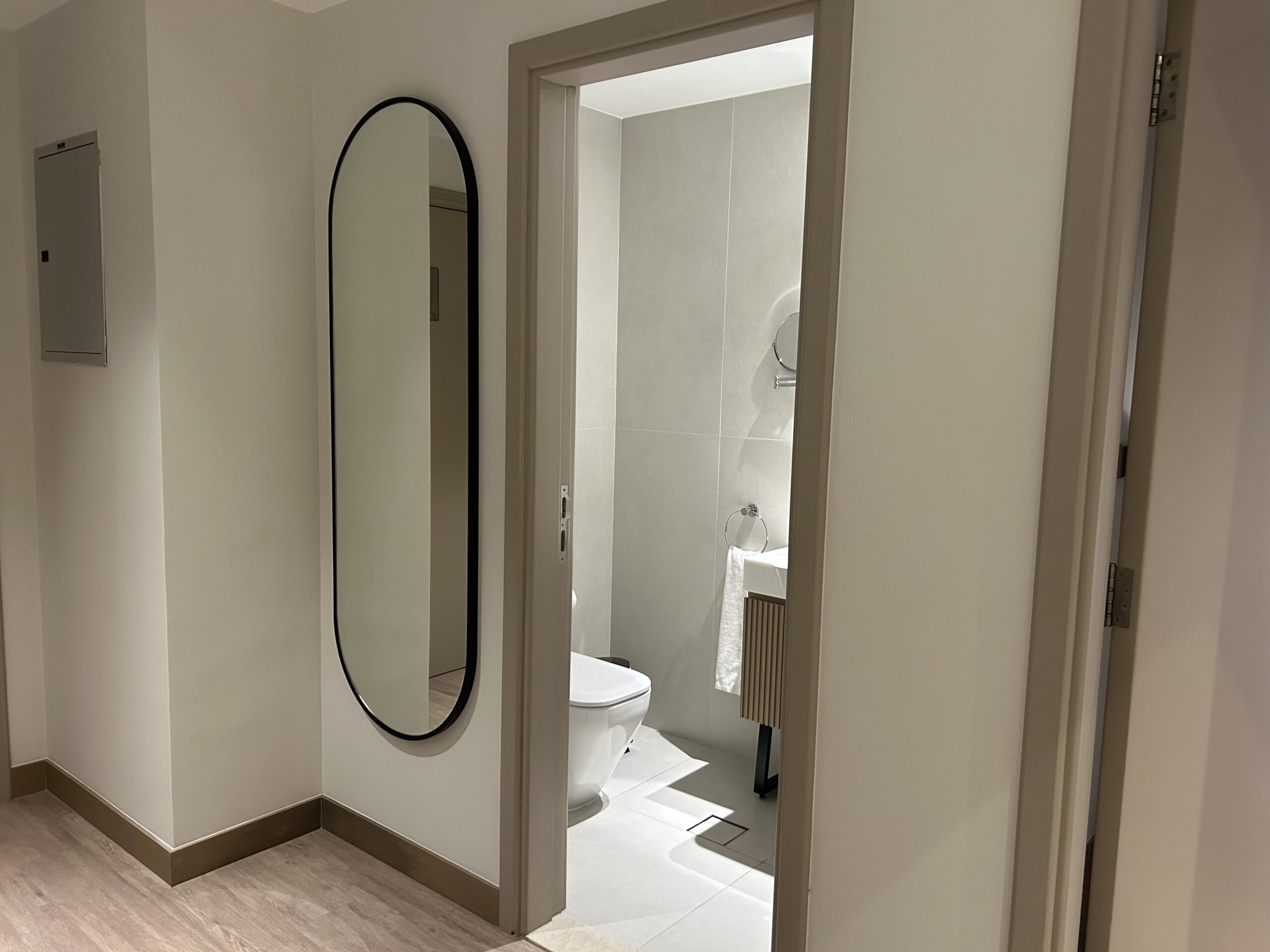 a bathroom with a mirror and toilet