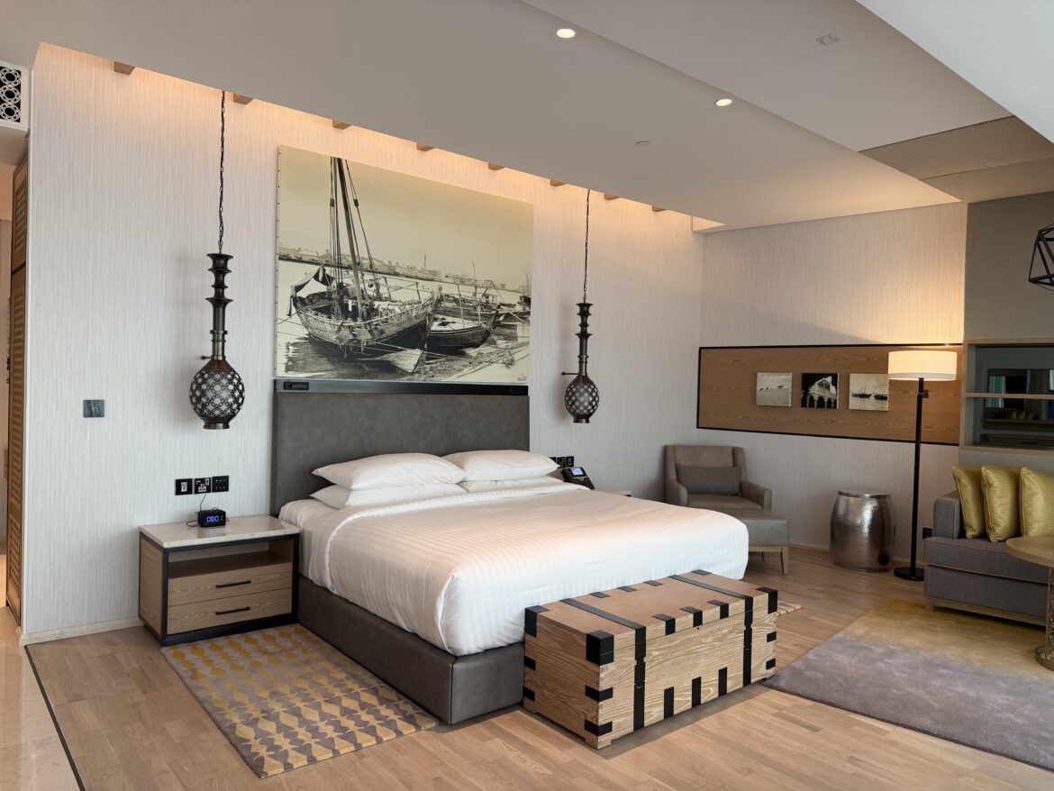 a bedroom with a bed and a picture on the wall