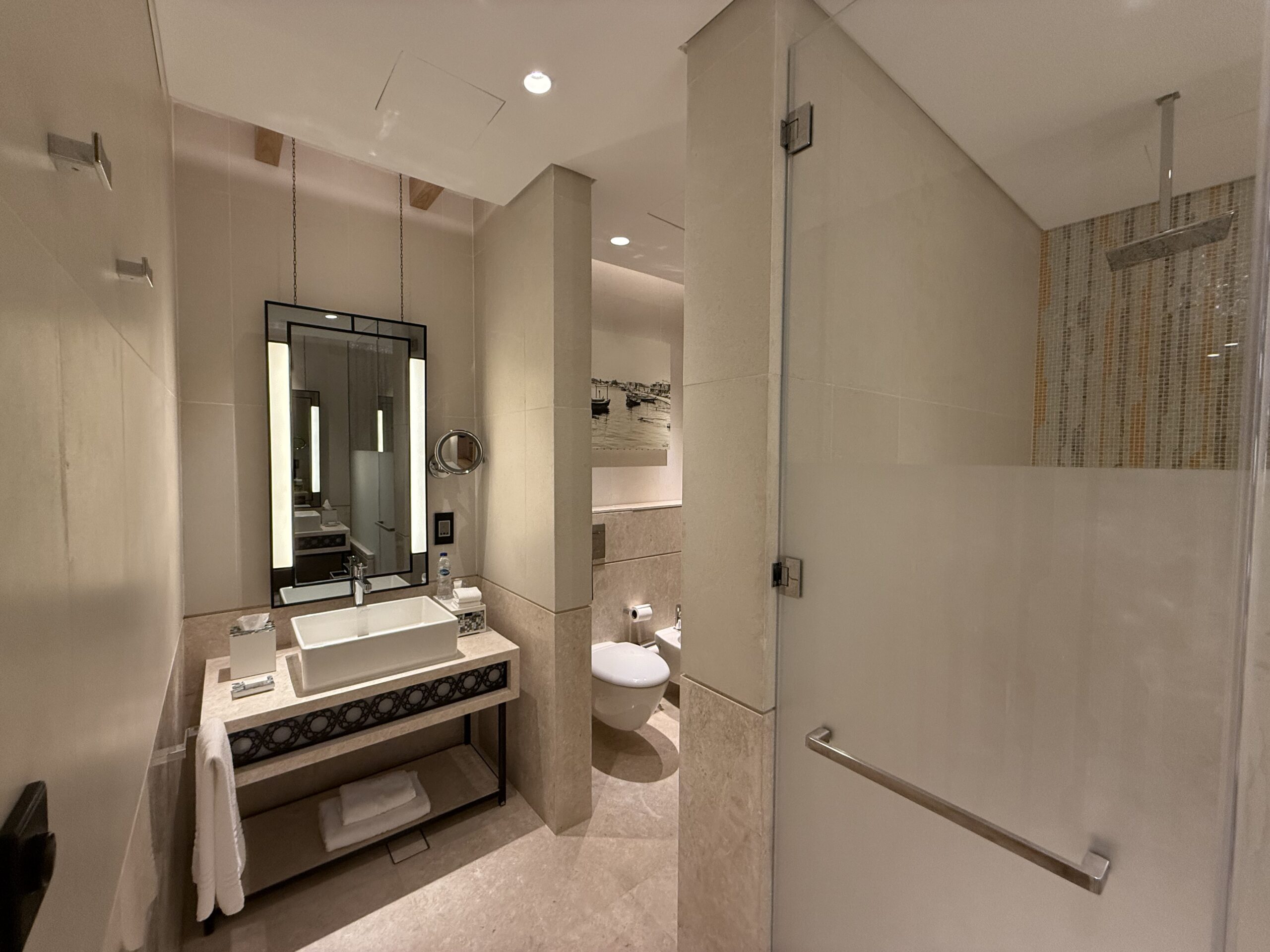 a bathroom with a sink toilet and mirror