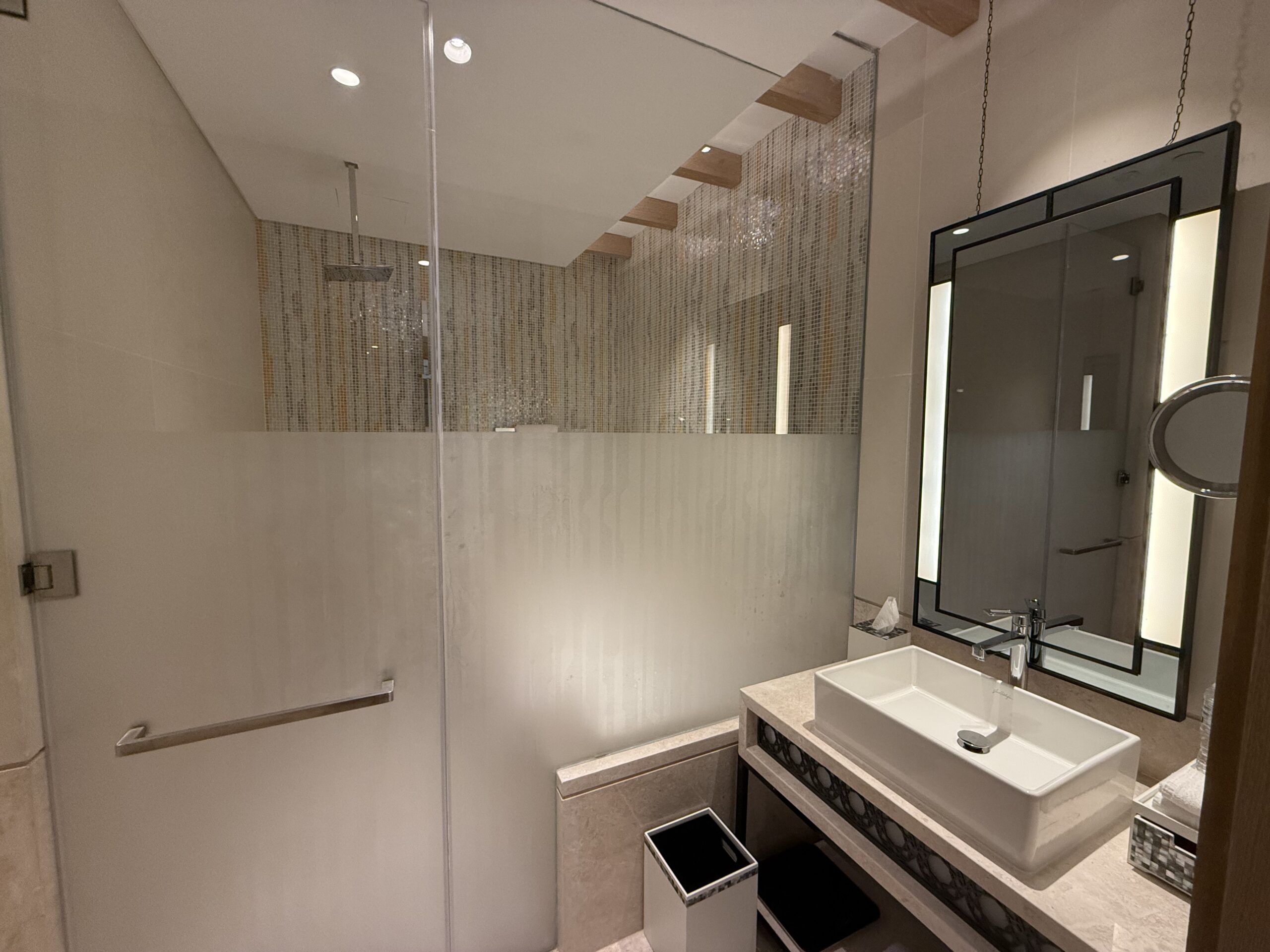 a bathroom with a glass shower door