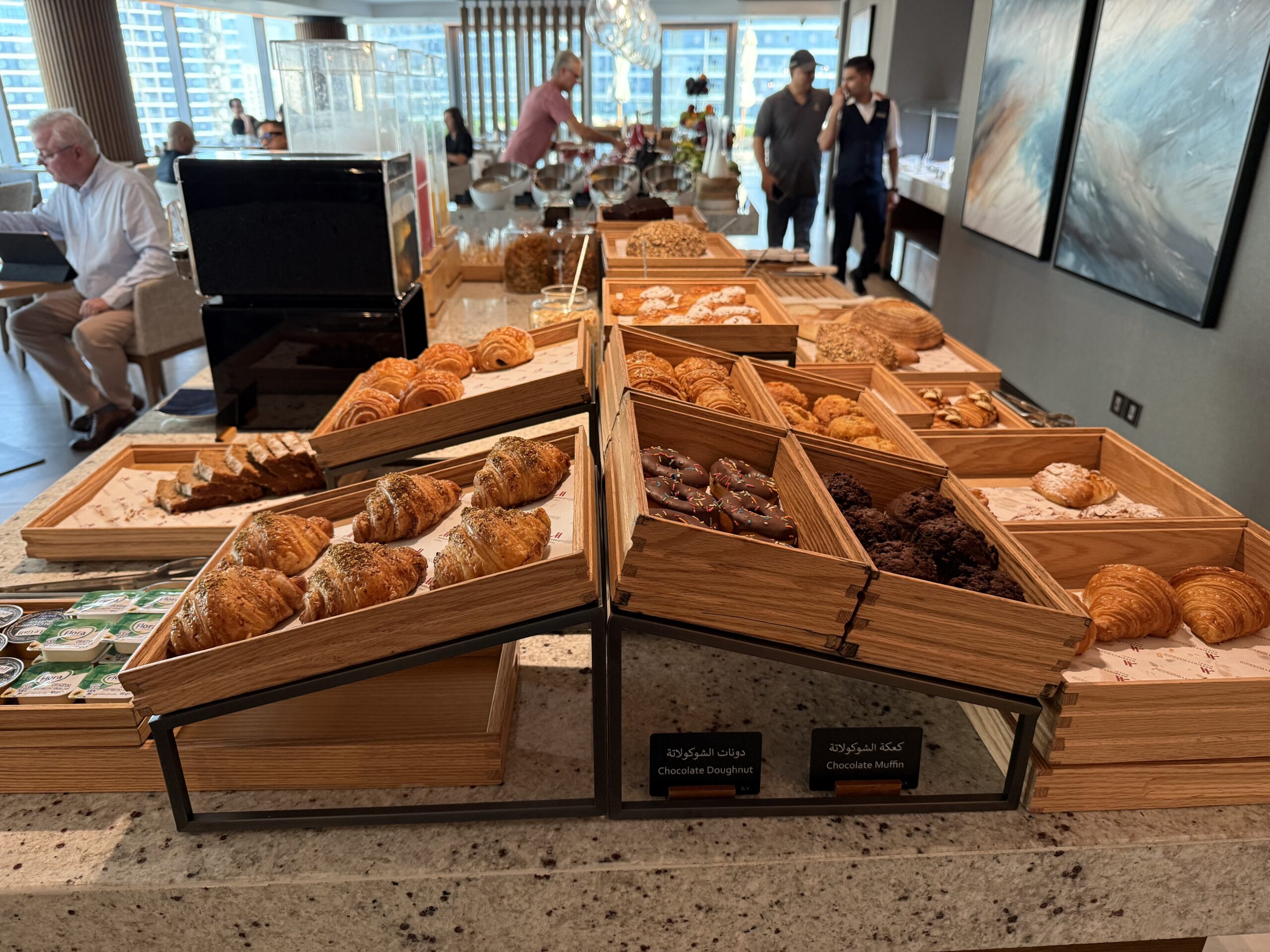 a group of people standing in front of a buffet