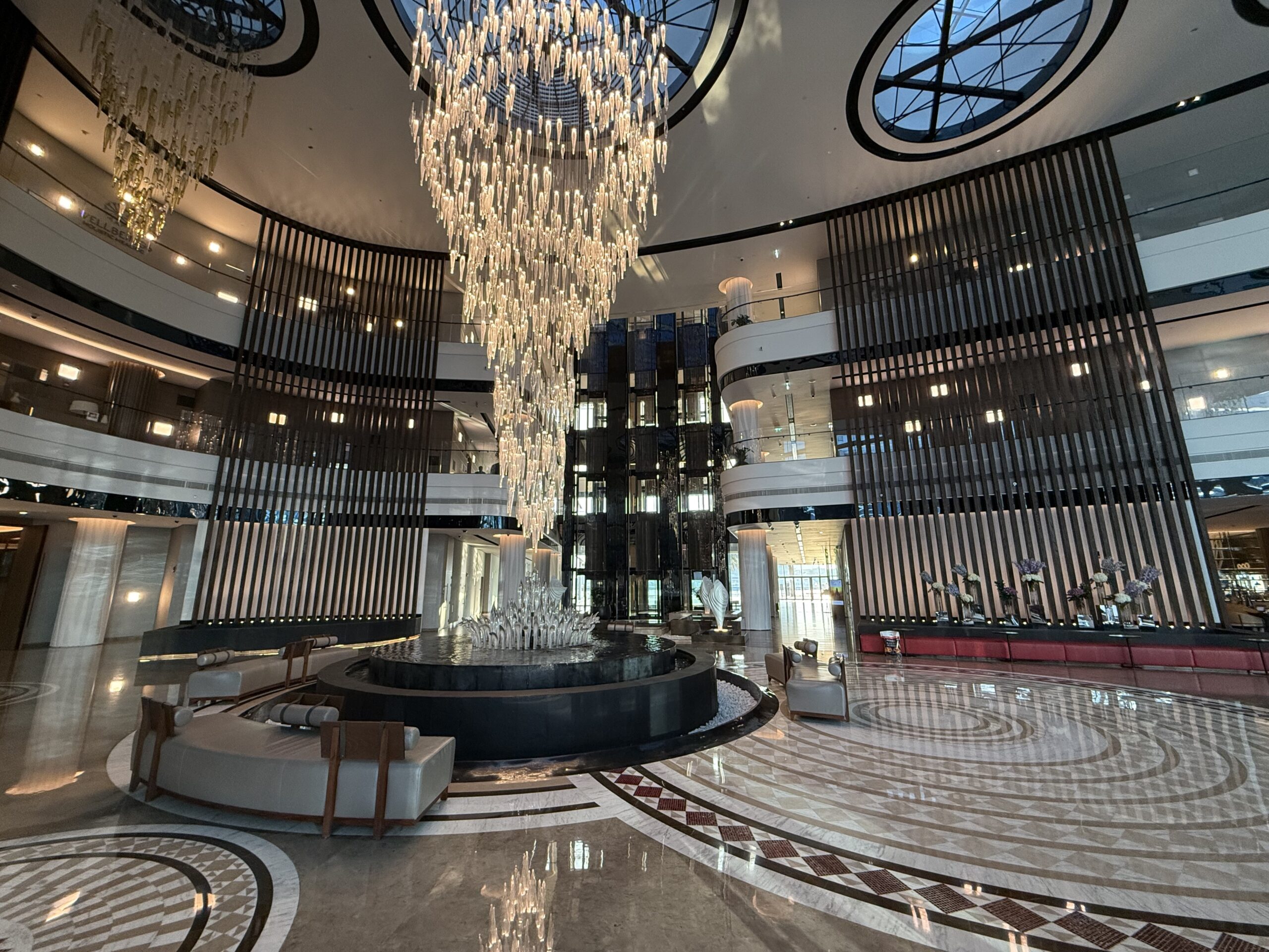 a large room with a chandelier and a circular floor