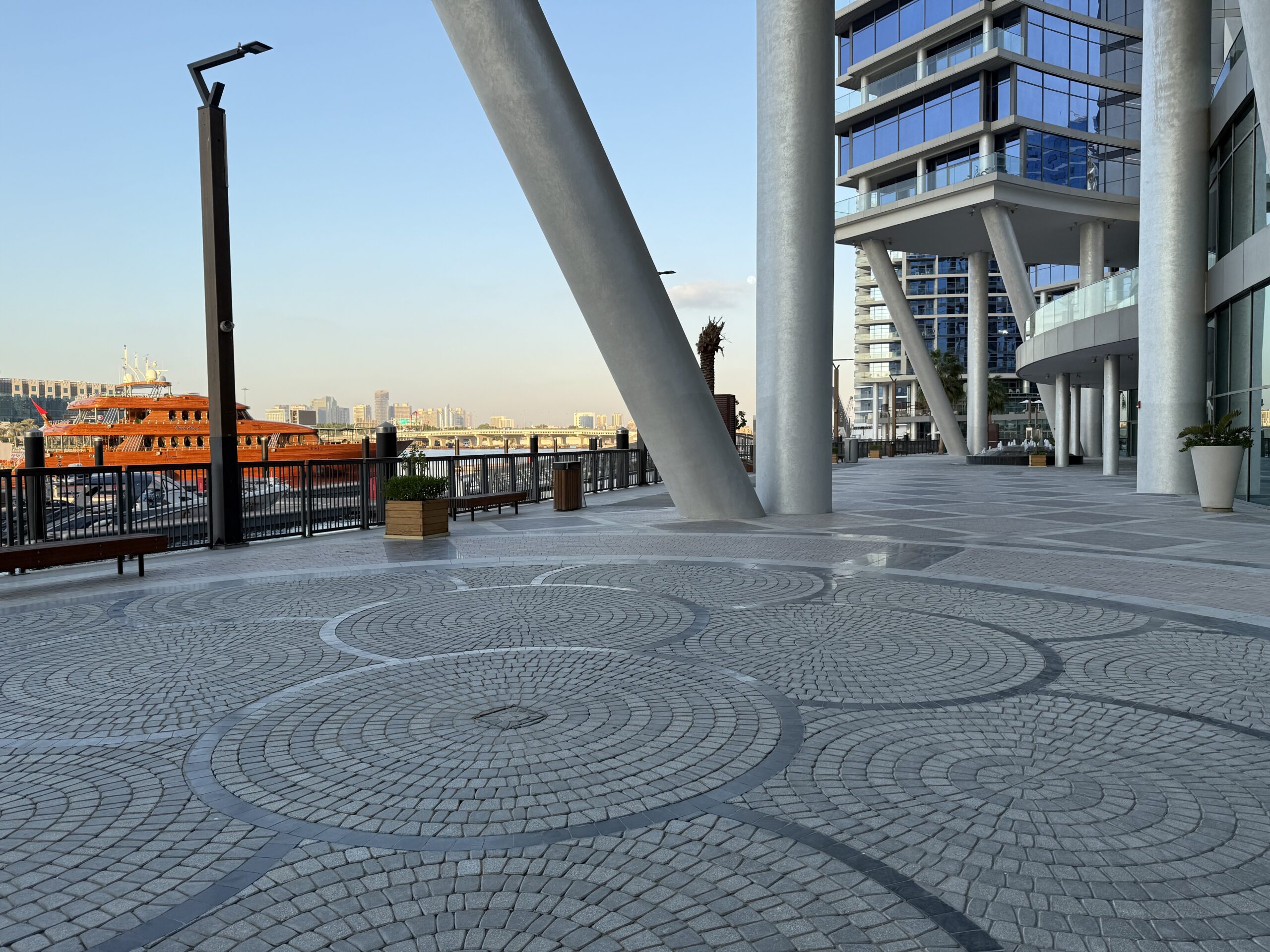 a stone walkway with a building in the background