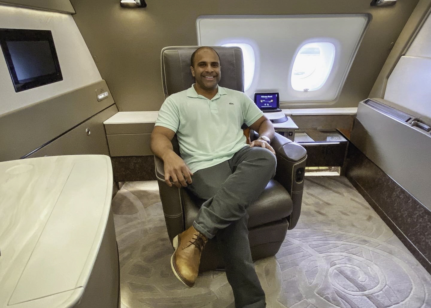 a man sitting in a chair in an airplane