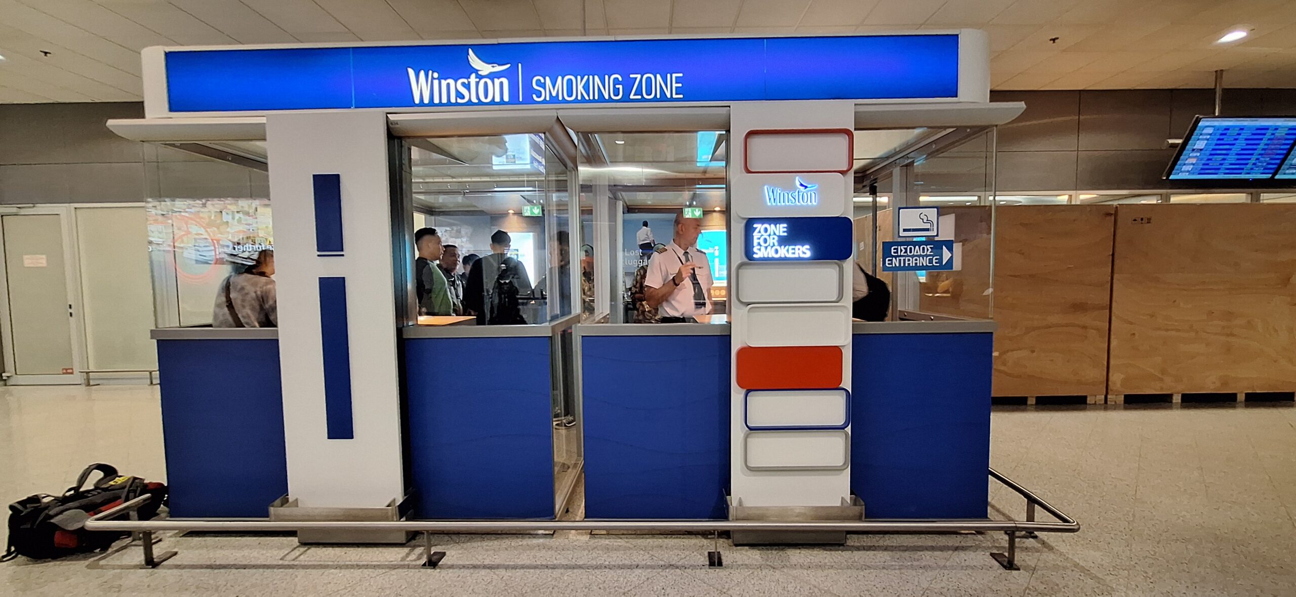 a group of people standing in front of a smoking zone