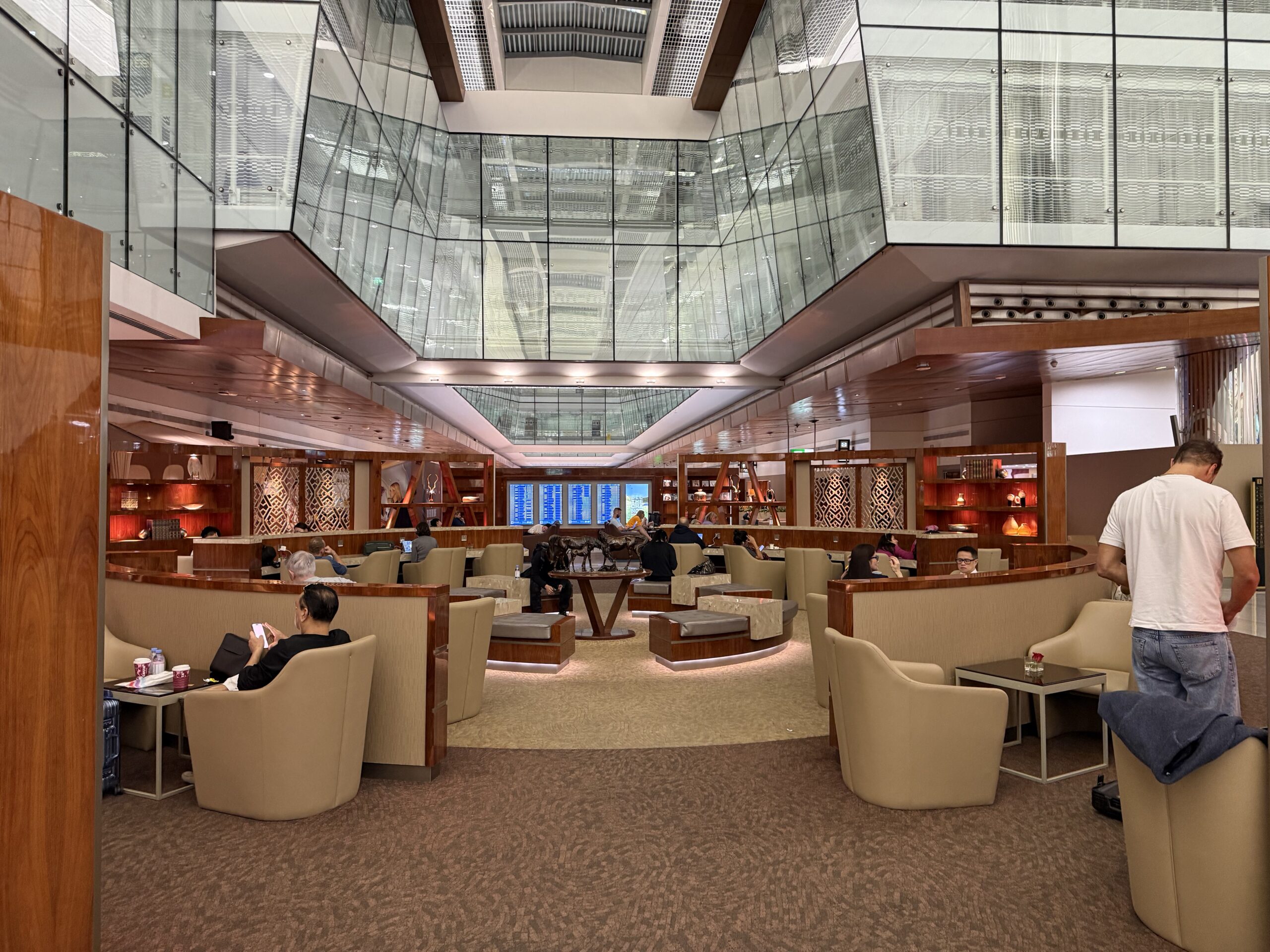 a group of people sitting in a room with glass walls