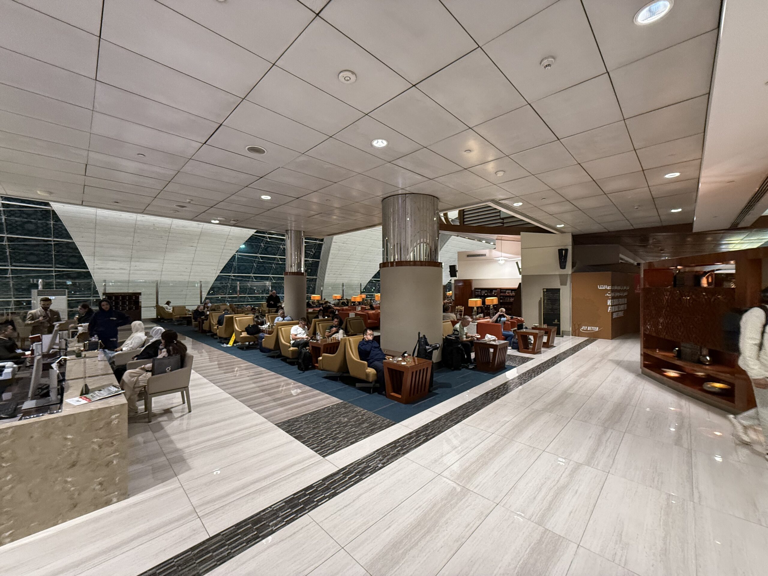 a room with a large white ceiling and a group of people sitting in chairs