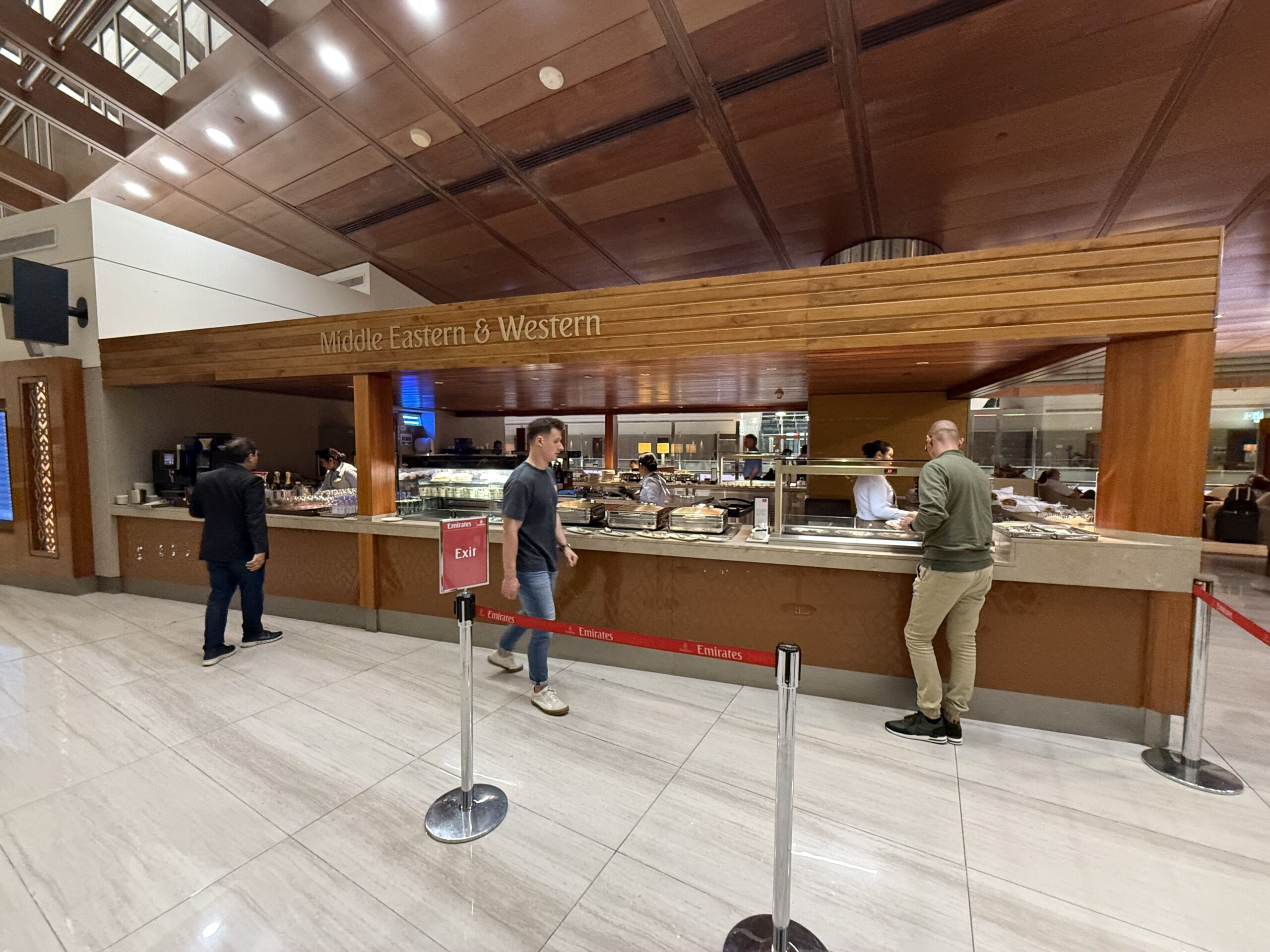 people standing in a line at a food court