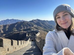 a woman taking a selfie on a great wall