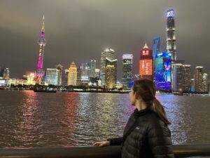 a woman looking at The Bund skyline