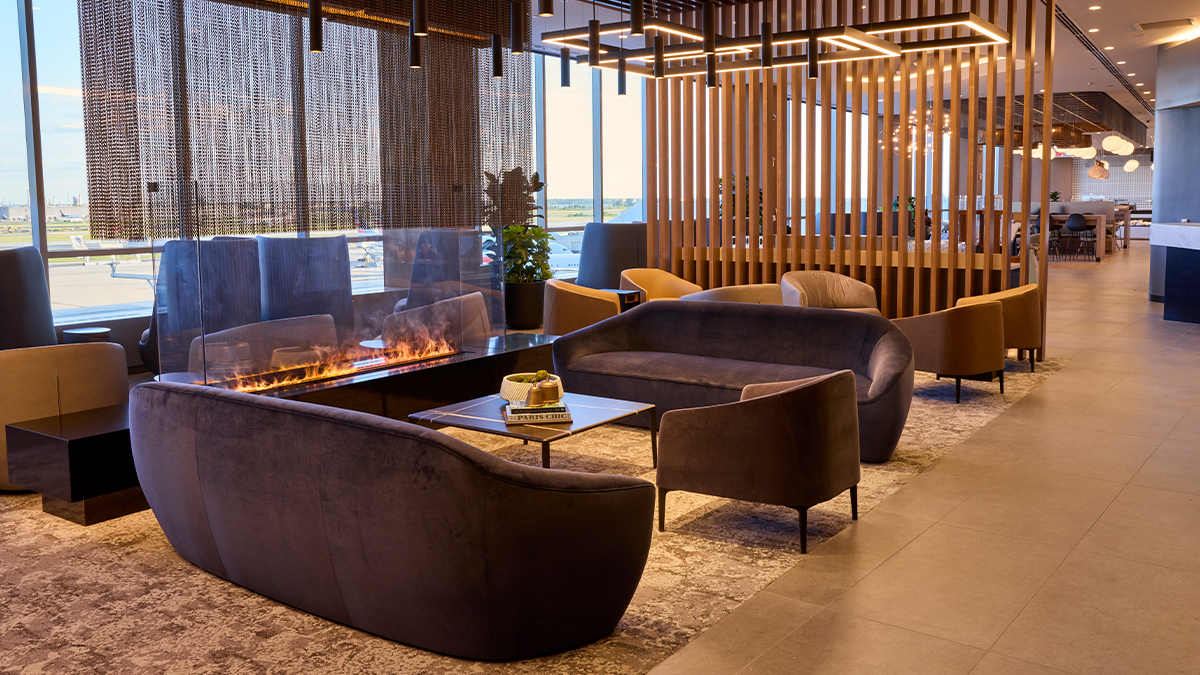 American Flagship Lounge PHL a room with couches and a fire
